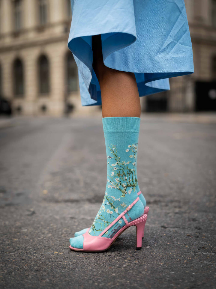 Van Gogh Almond Blossom art socks worn with pink heels and blue skirt in Paris – museum art gift from ArtyGifts
