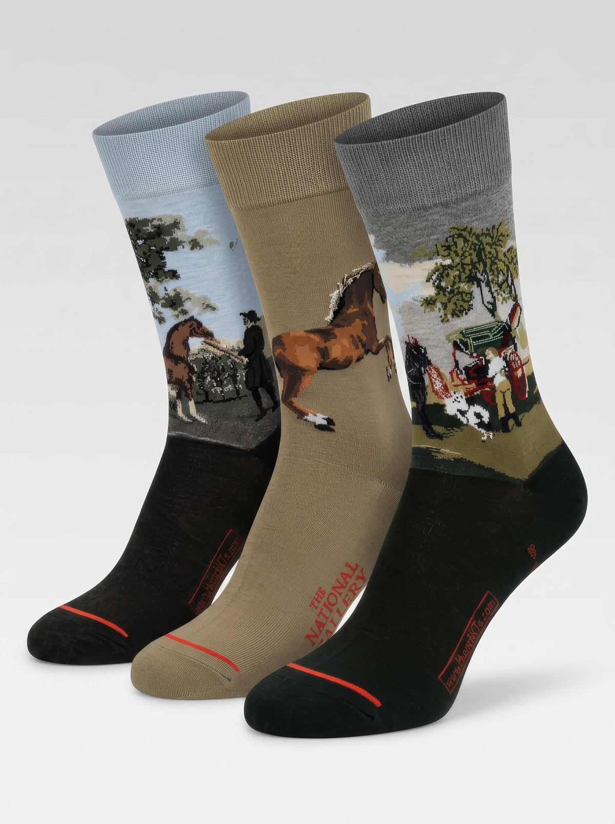 Three ArtyGifts socks in black, taupe and charcoal, each featuring a different George Stubbs horse painting against a light backdrop.
