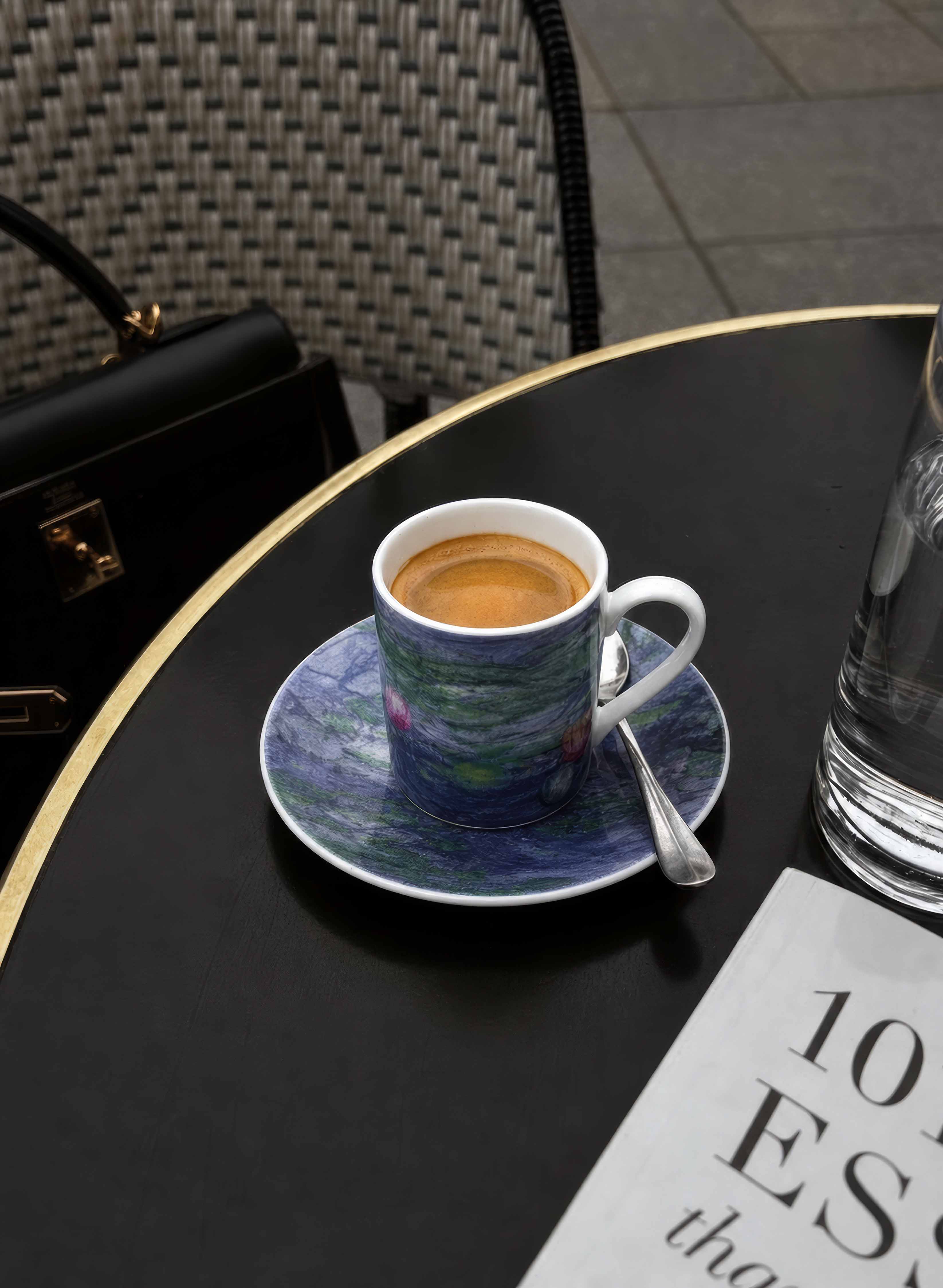 ArtyGifts espresso cup with Water Lilies by Monet design on dark table – lifestyle shot