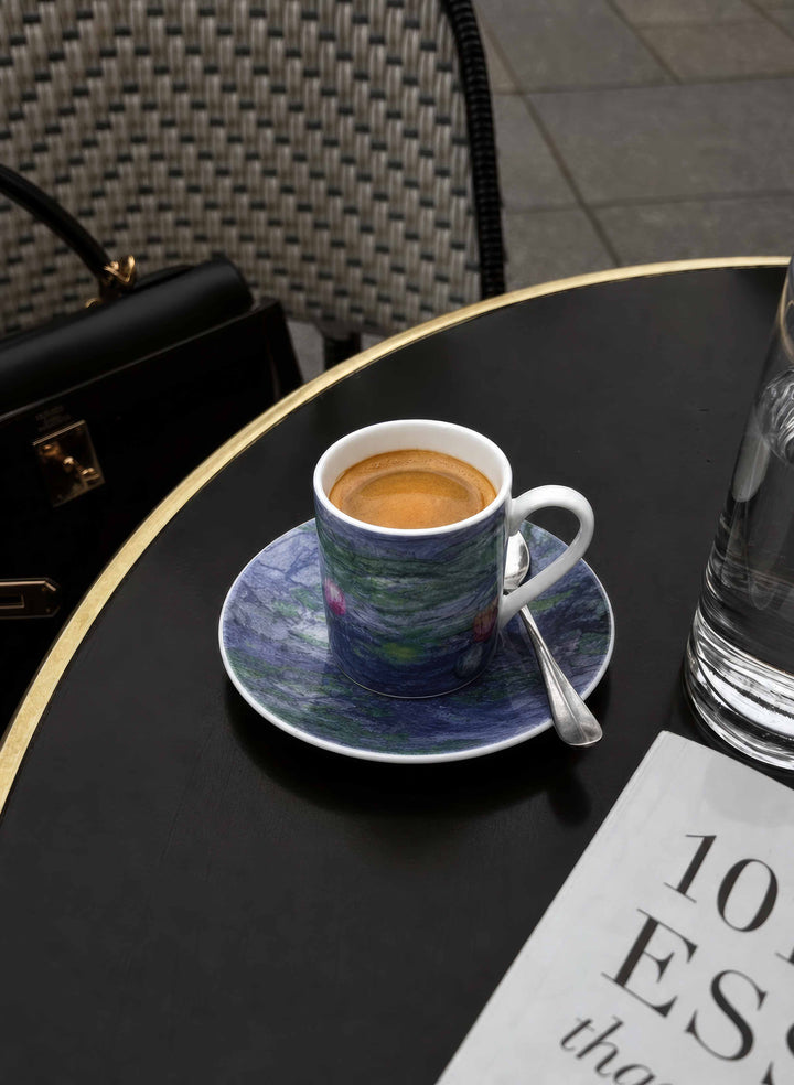 ArtyGifts espresso cup with Water Lilies by Monet design on dark table – lifestyle shot