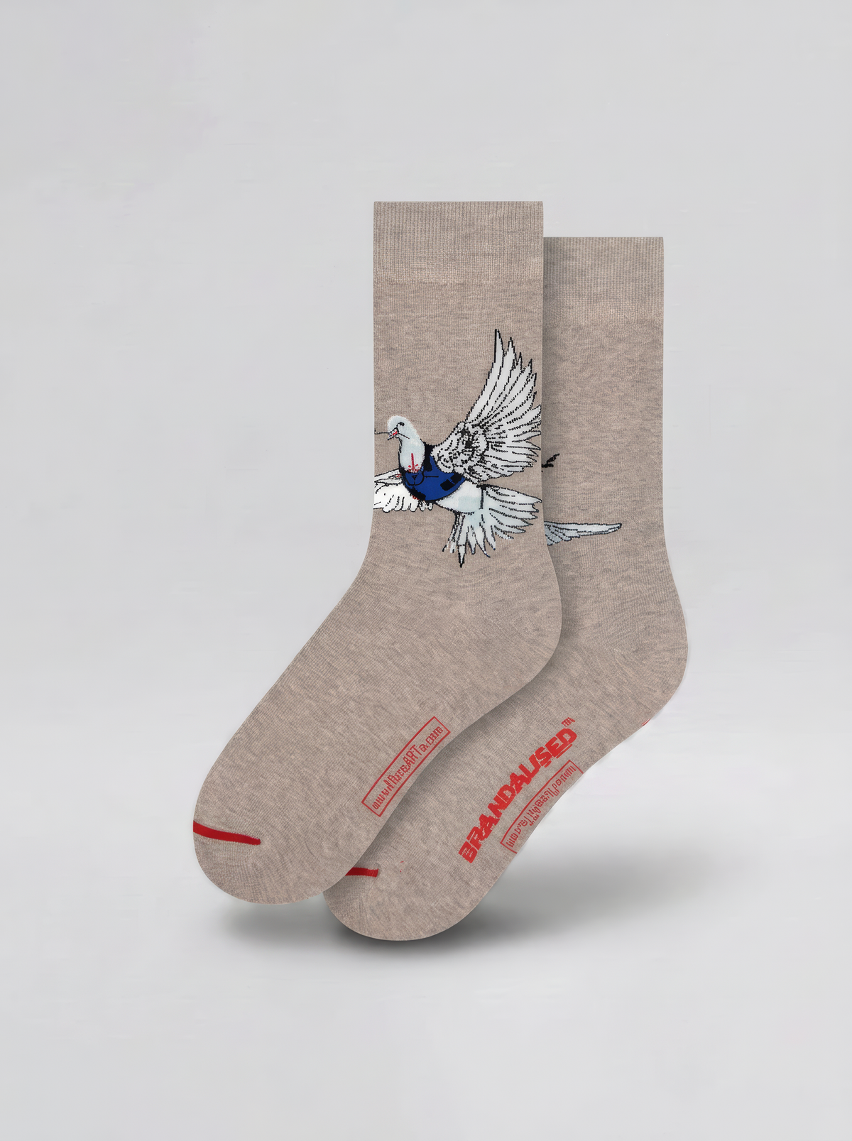 Pair of warm grey Banksy-inspired Peace Dove art socks with a black and white dove motif and red accents, displayed against a pale background.
