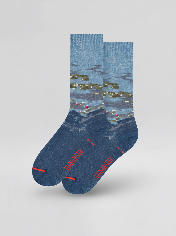 Back view of a pair of blue XL crew socks featuring Claude Monet’s Water Lilies by Evening Light, with red toe accents.