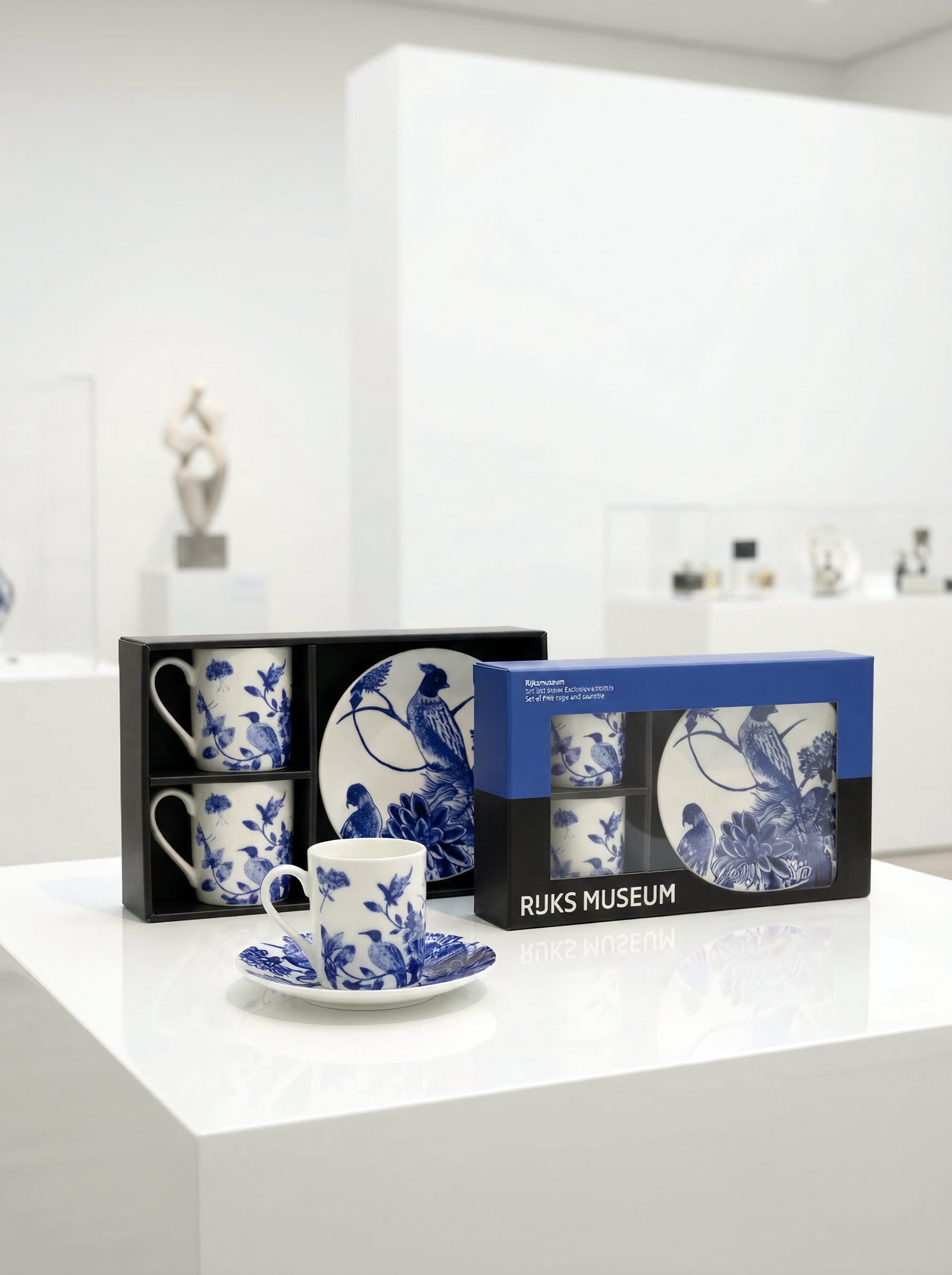 Set of Delft blue and white ceramic tea cups and saucers with packaging on a white surface.