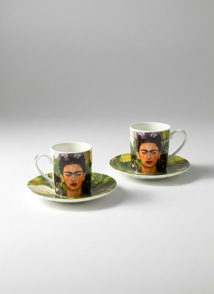 Two coffee cups with saucers featuring a portrait on a gray background