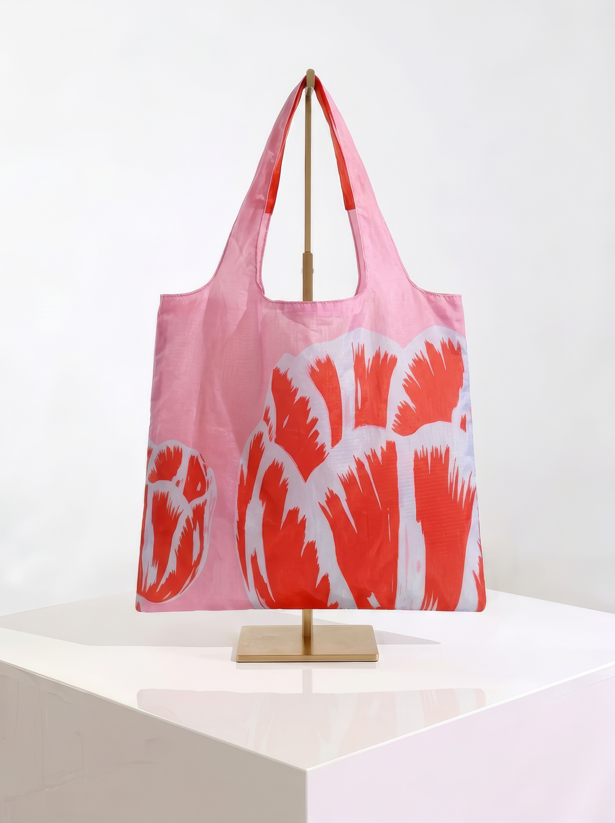 Foldable museum art shopper bag featuring Modern Tulip Red, displayed on a gold stand against a white museum-style background from ArtyGifts
