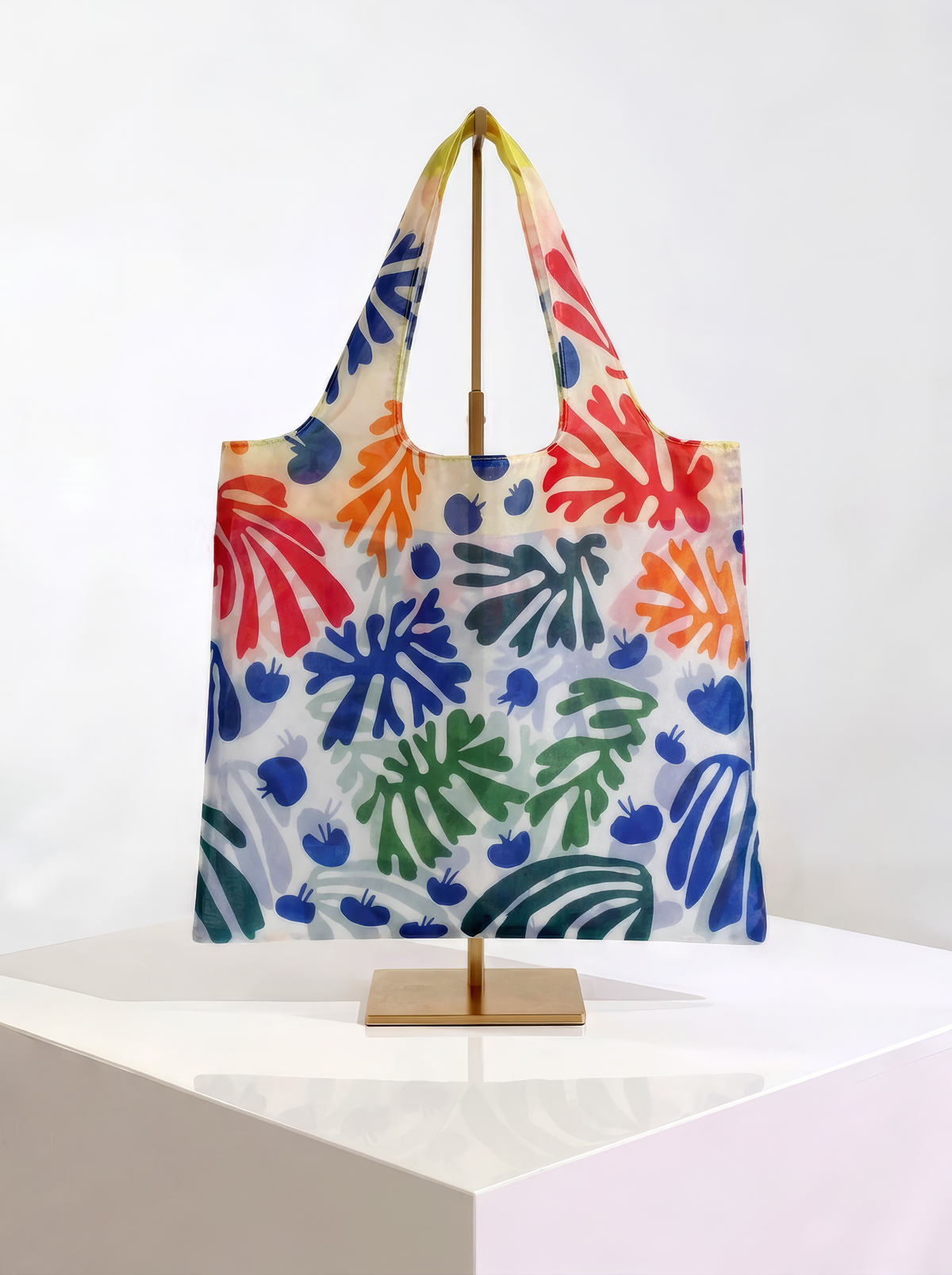 Foldable museum art shopper bag featuring The Parakeet and the Mermaid by Henri Matisse, displayed on a gold stand against a white museum-style background from ArtyGifts
