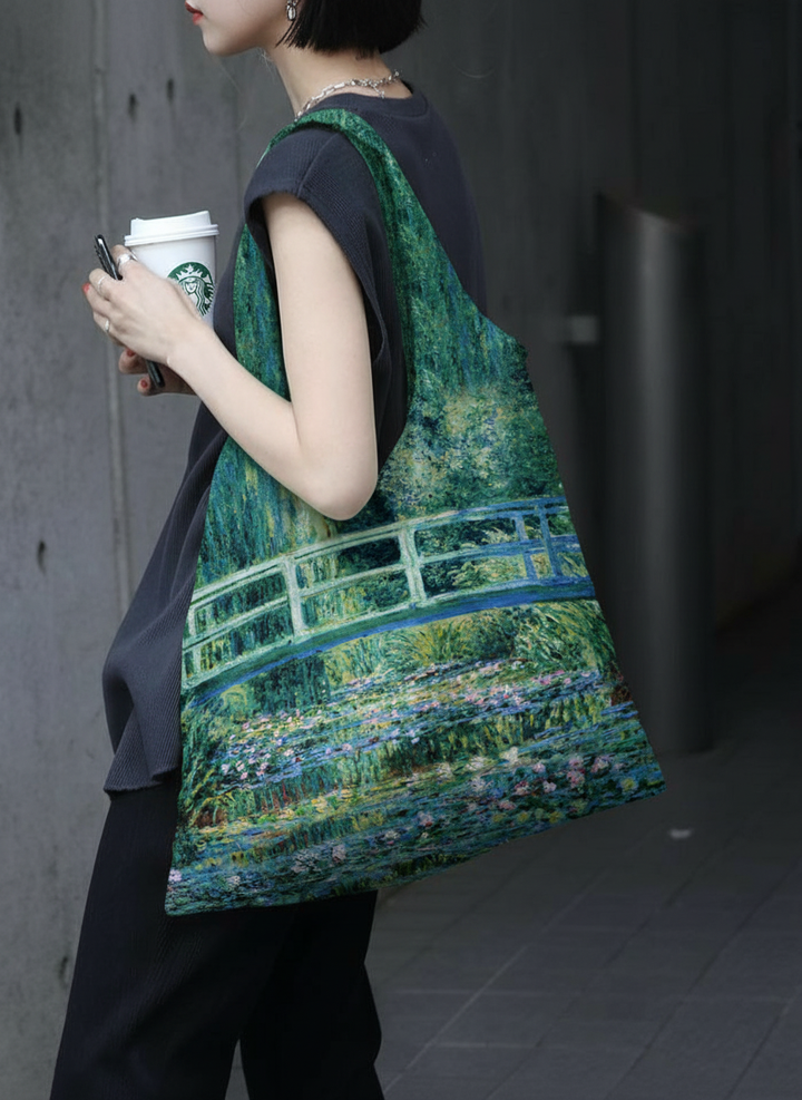 Foldable Shopper Bag Japanese Bridge Claude Monet – woman carrying art bag on the street | ArtyGifts
