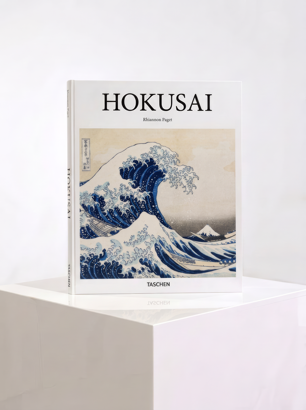 Hokusai hardcover art book by Rhiannon Paget, published by TASCHEN, featuring The Great Wave off Kanagawa on the cover, displayed on a white plinth.
