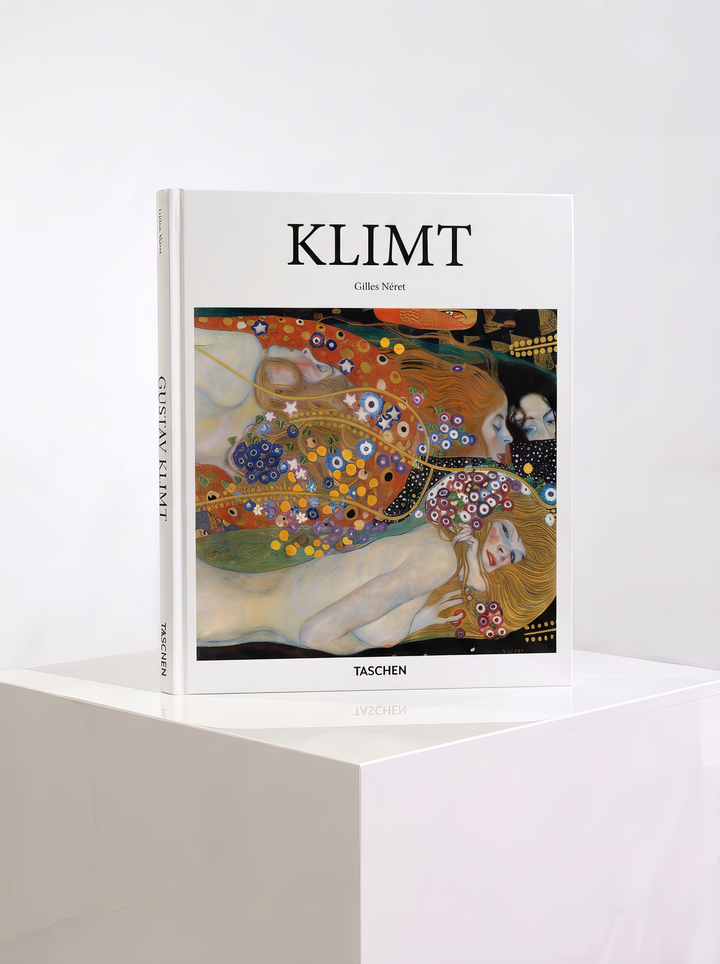 Klimt hardcover art book by Gilles Néret, published by TASCHEN, featuring women and colourful decorative patterns on the cover, displayed on a white plinth.
