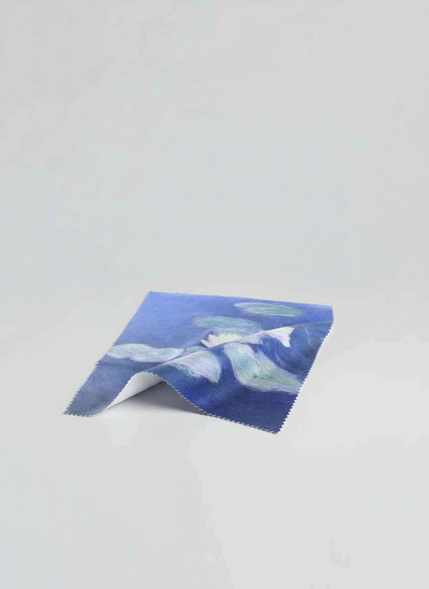 Microfiber lens cloth featuring Water Lilies in Evening Light by Claude Monet, flat lay on white background
