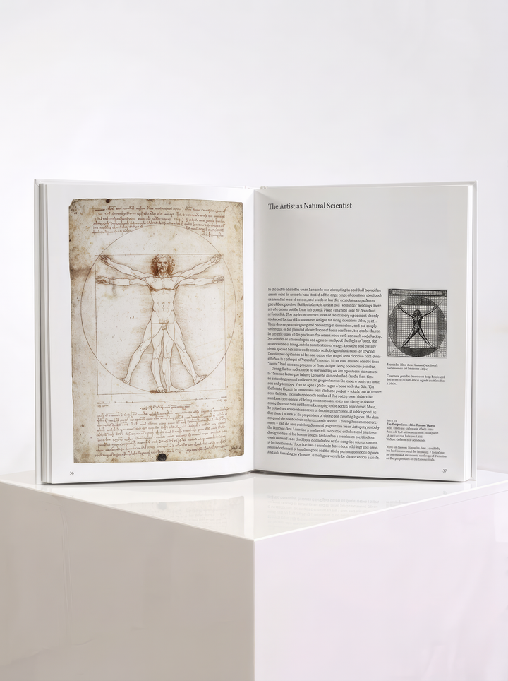 Open TASCHEN Leonardo da Vinci art book displayed on a white plinth, showing an illustration on the left and text with a smaller image on the right.
