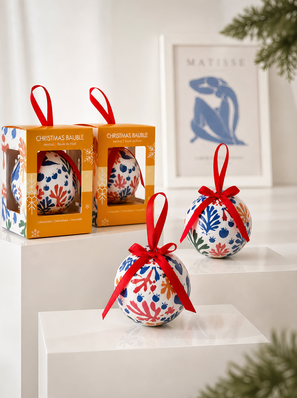 Matisse Parakeet and Mermaid Christmas baubles with gift boxes in front of Matisse Blue Nude print – officially licensed museum art ornament from ArtyGifts

