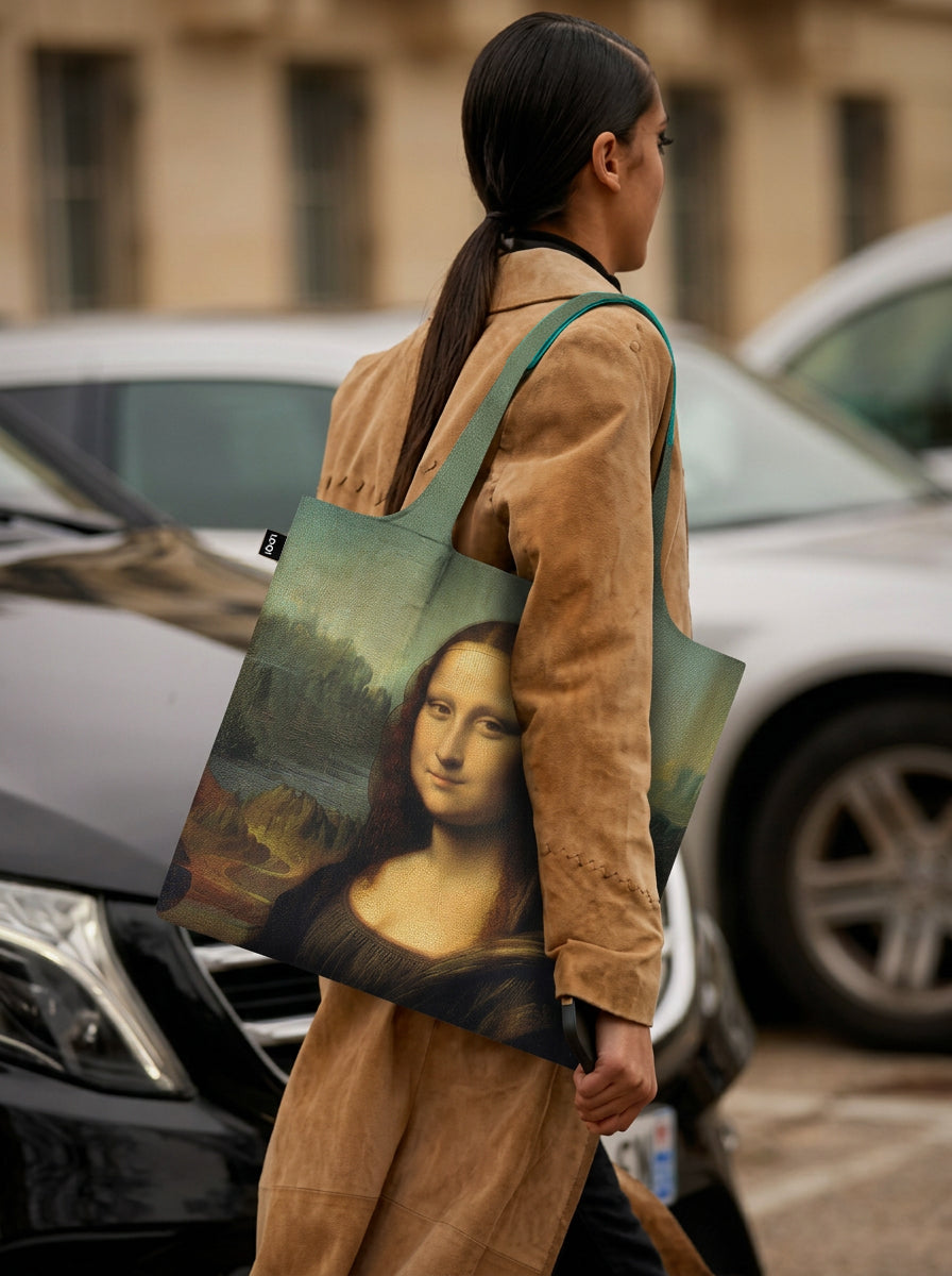 Mona Lisa foldable shopper bag worn by model in beige jacket on city street – Leonardo da Vinci art tote from ArtyGifts