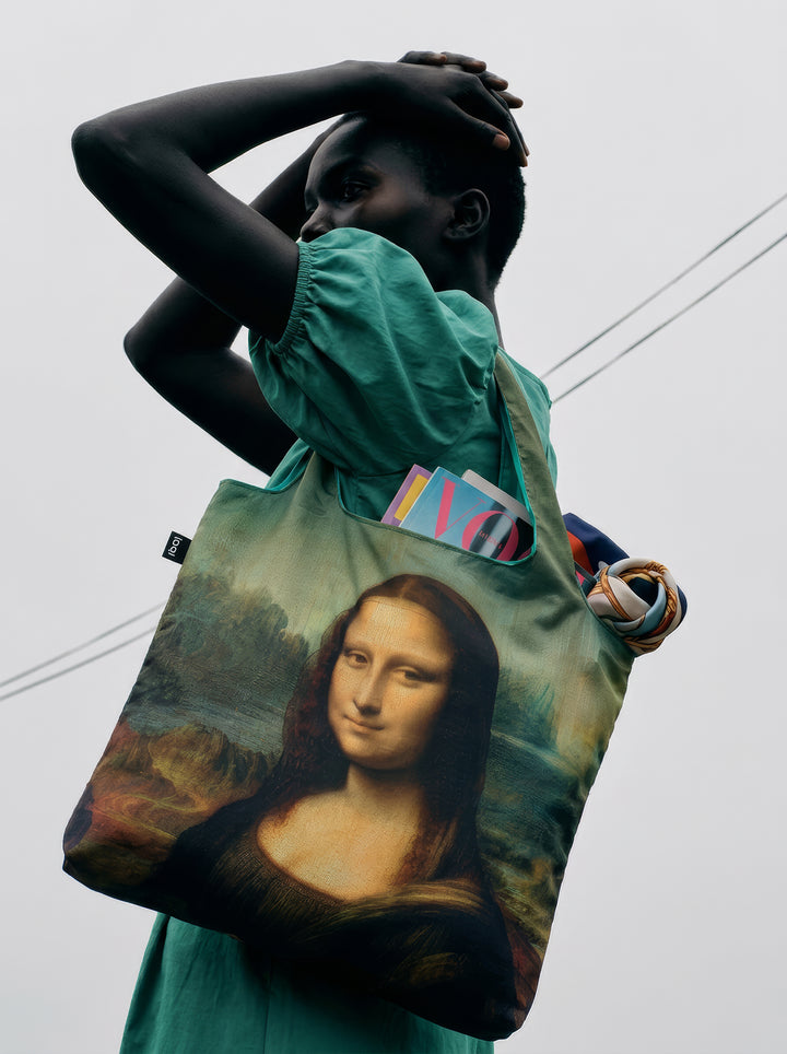 Mona Lisa foldable shopper bag carried by model with Vogue magazine – Leonardo da Vinci art tote from ArtyGifts