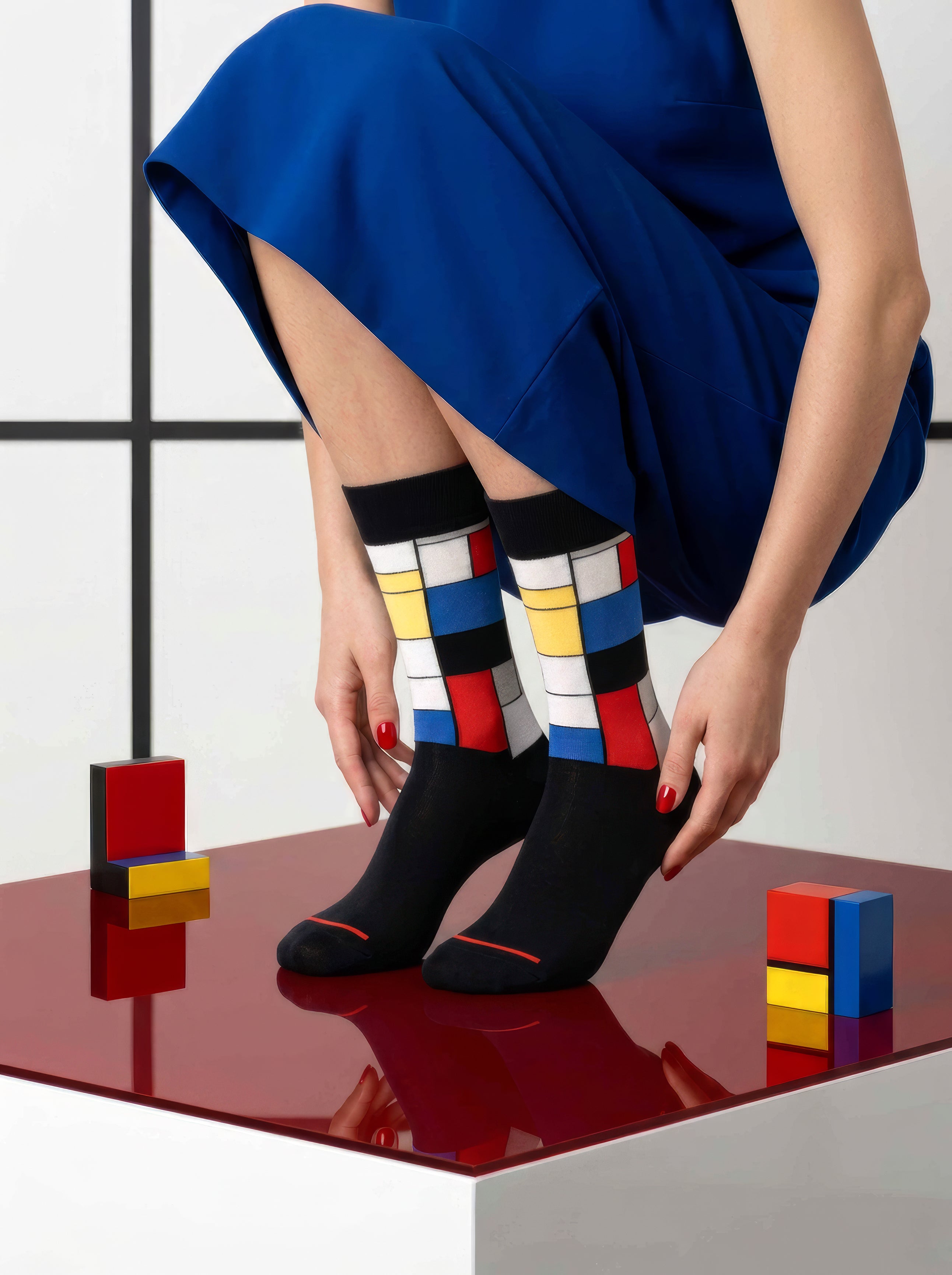 Mondrian Composition art socks with blue dress and Mondrian colour block props – museum art gift from ArtyGifts

