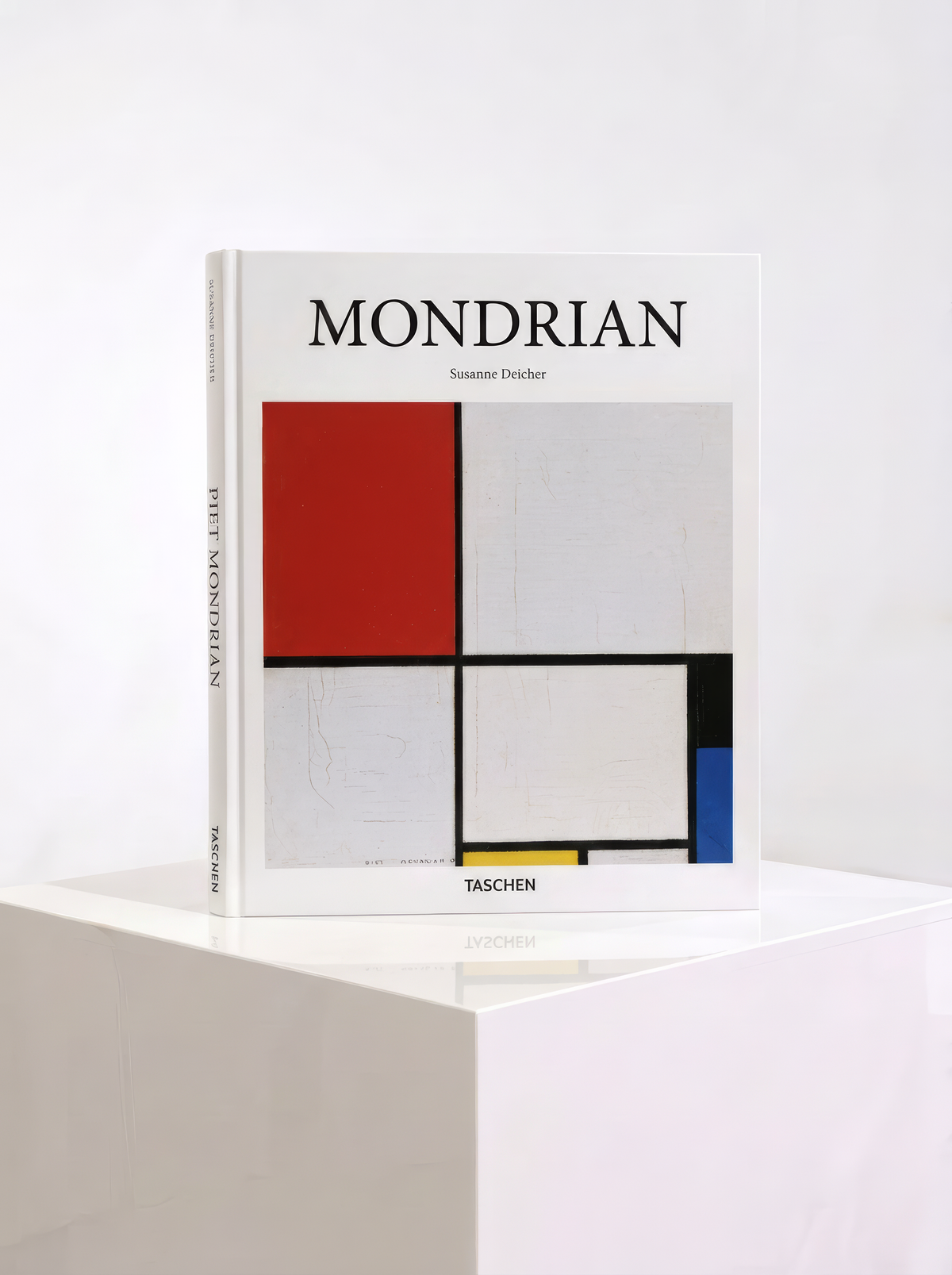 Mondrian hardcover art book by Susanne Deicher, published by TASCHEN, with a red, blue and yellow geometric composition on the cover, displayed on a white plinth.
