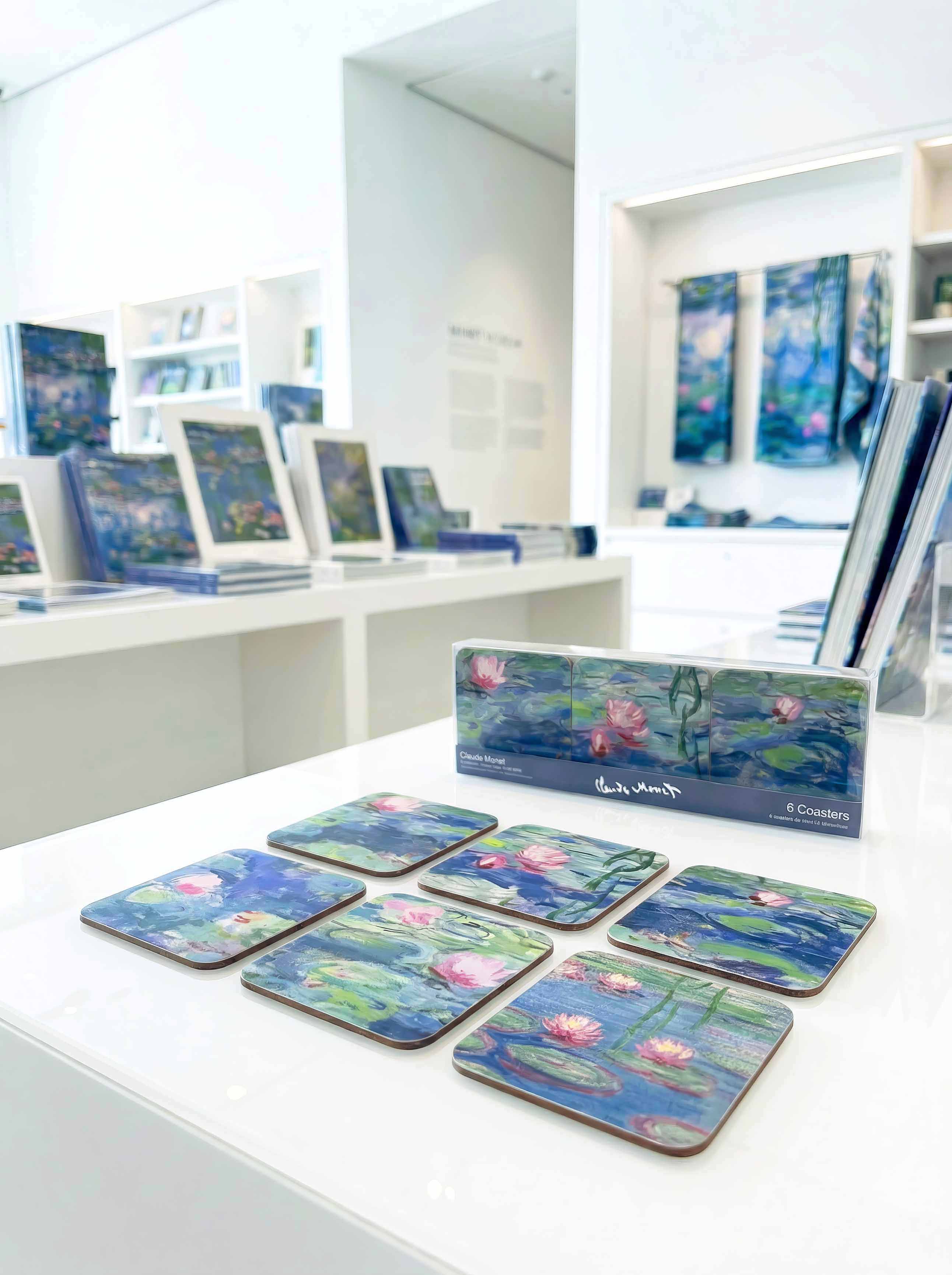 Monet Water Lilies cork coasters on museum table with gift box — museum art gift | ArtyGifts