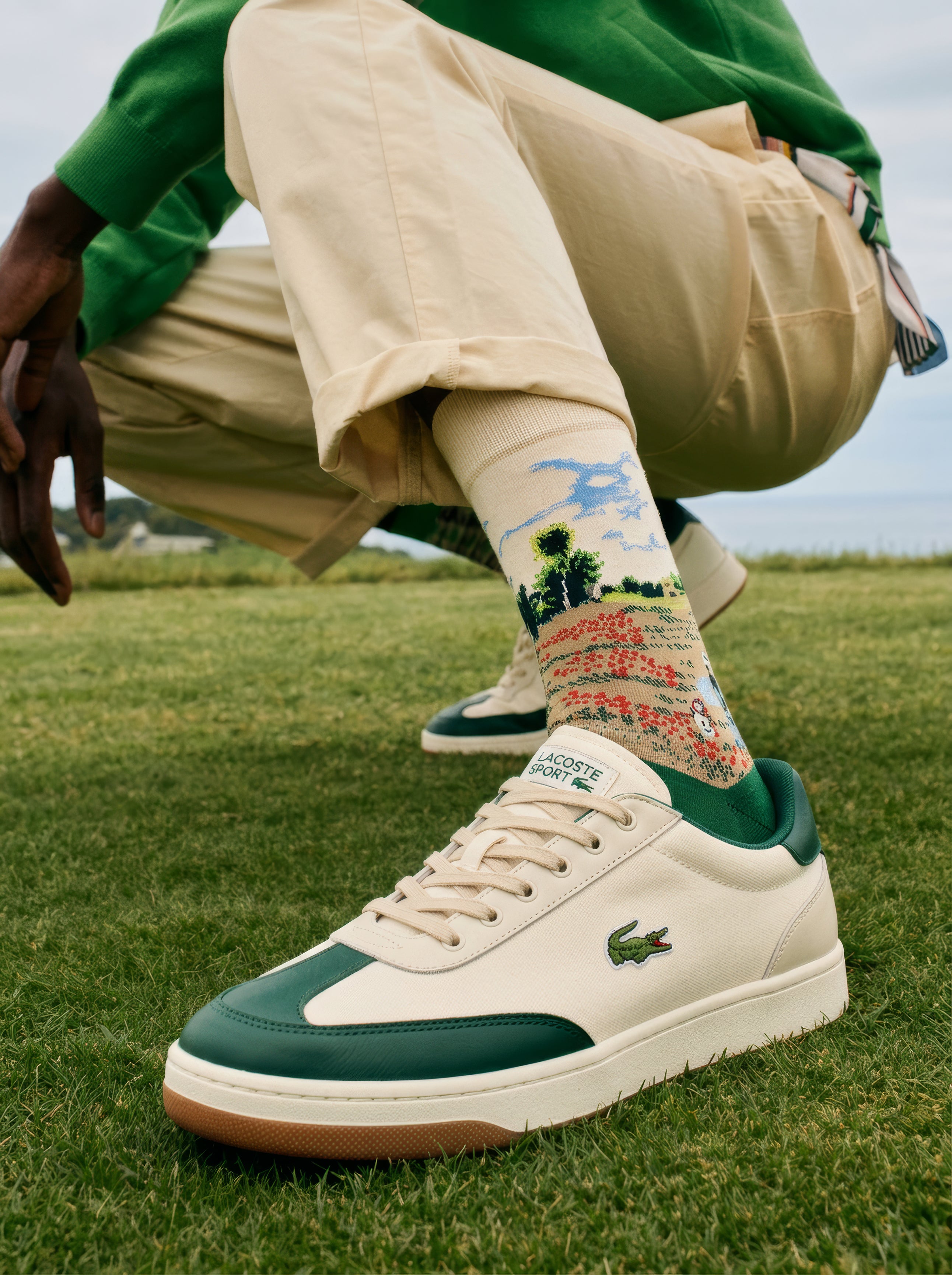 Monet Field of Poppies art socks worn with Lacoste sneakers on grass – unisex museum gift from ArtyGifts
