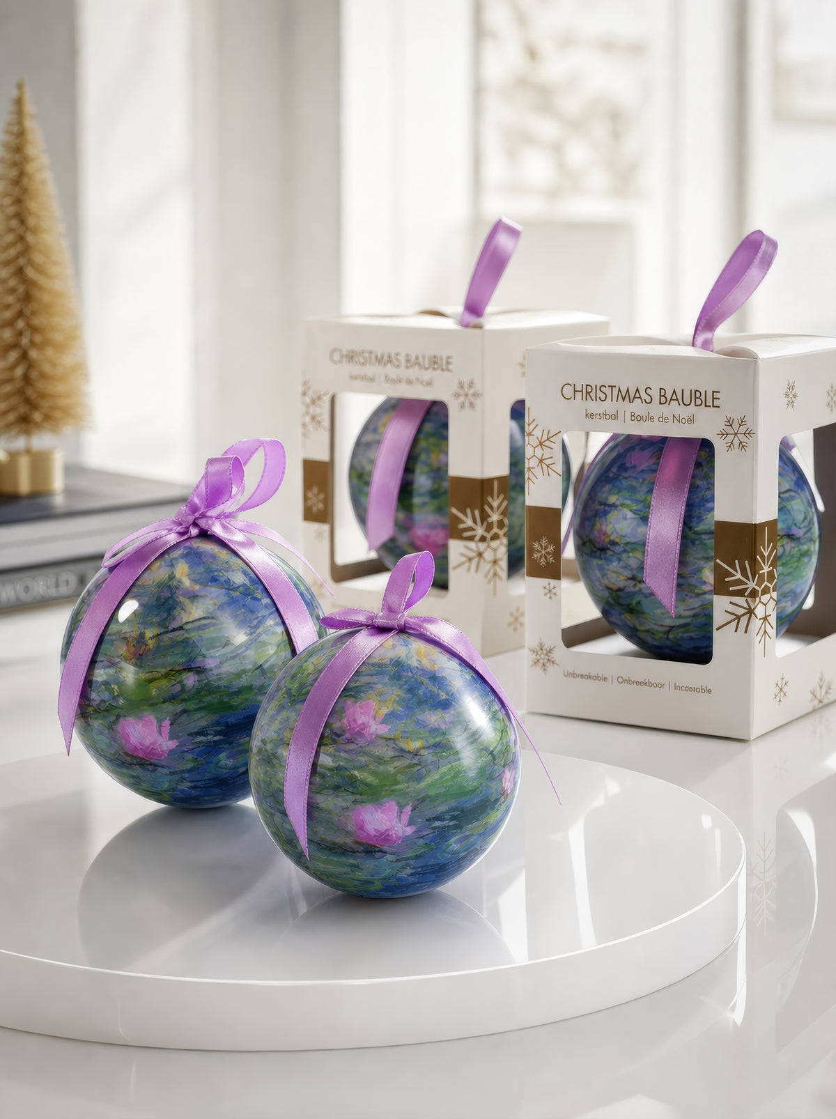 Monet Water Lilies Christmas baubles with gift boxes and purple ribbons on white surface – officially licensed museum art ornament from ArtyGifts
