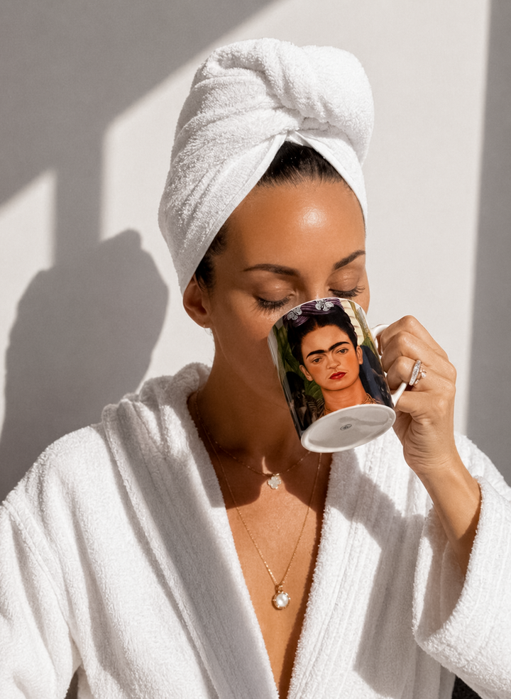 Woman drinking from Self Portrait Frida Kahlo mug by Frida Kahlo — ArtyGifts Mug Set

