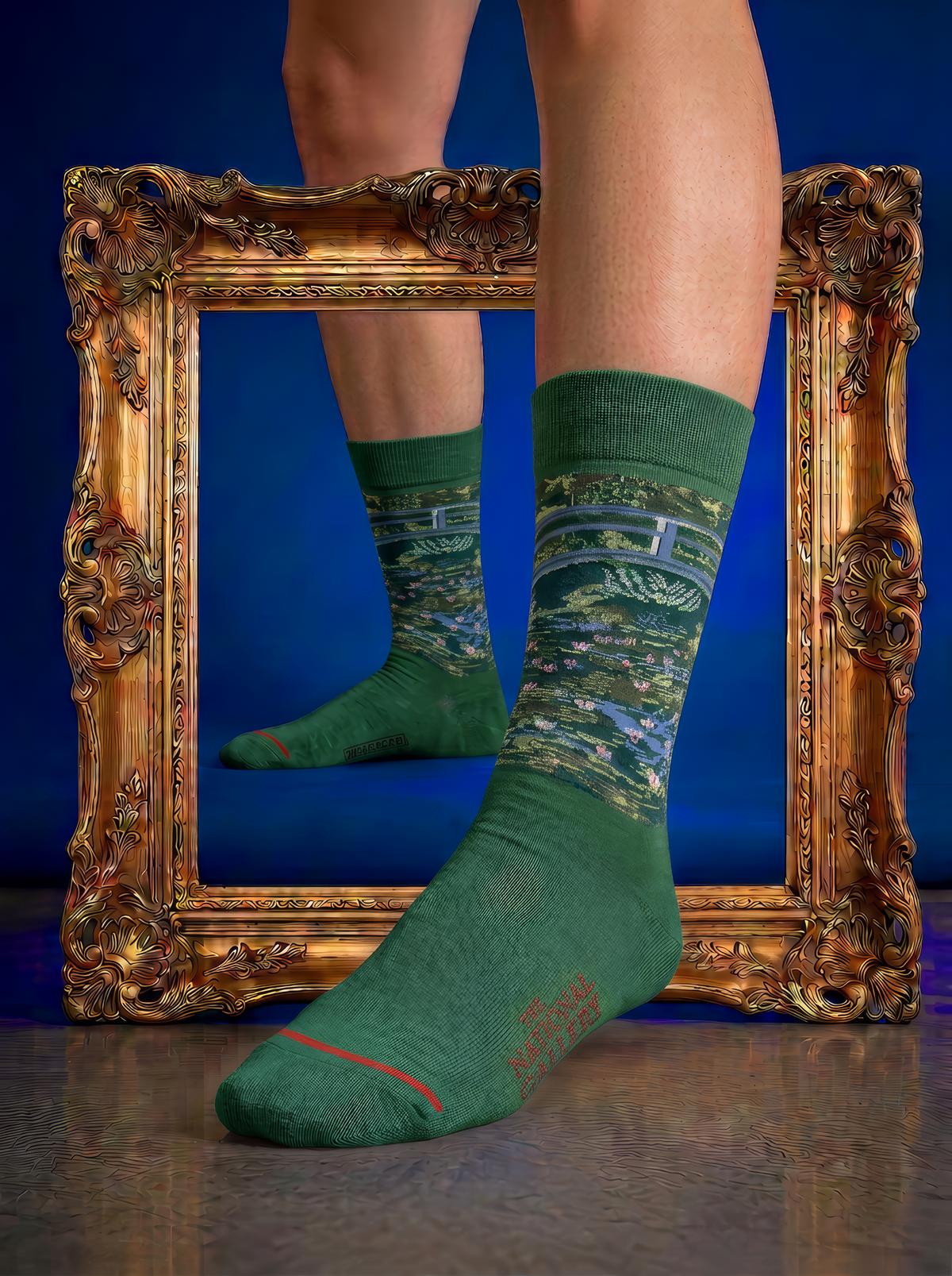 Green Claude Monet The Japanese Bridge art socks shown with green shoes in front of an ornate gold frame. A wearable art gift for women and men.