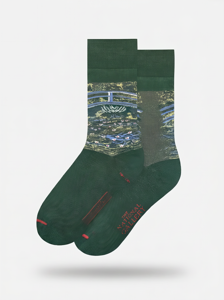 Pair of officially licensed green Claude Monet The Japanese Bridge art socks for women and men, shown on a white background. A thoughtful birthday or Christmas gift for art lovers.