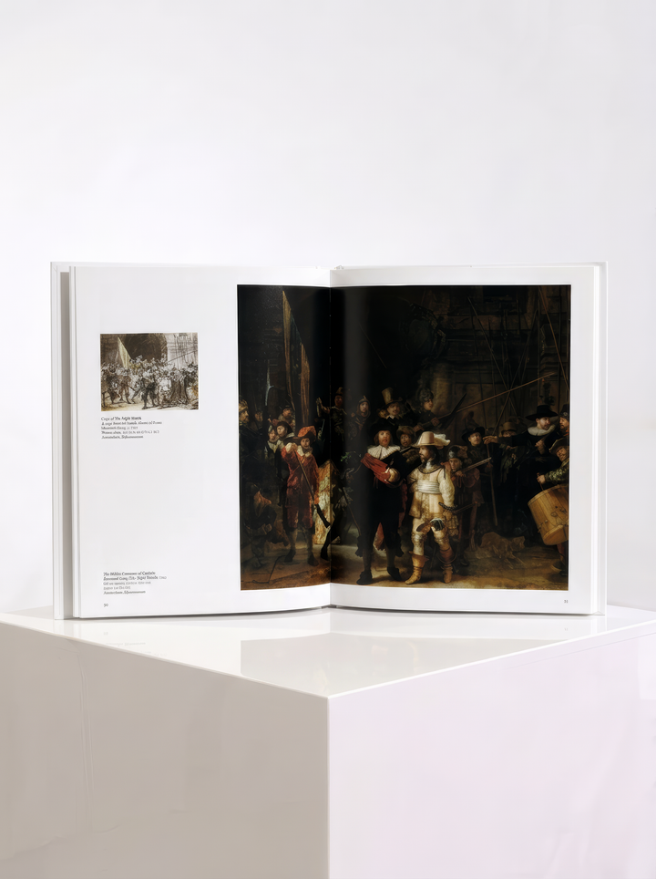 Open TASCHEN Rembrandt art book displayed on a white plinth, showing The Night Watch across the pages with a smaller illustration and captions on the left.
