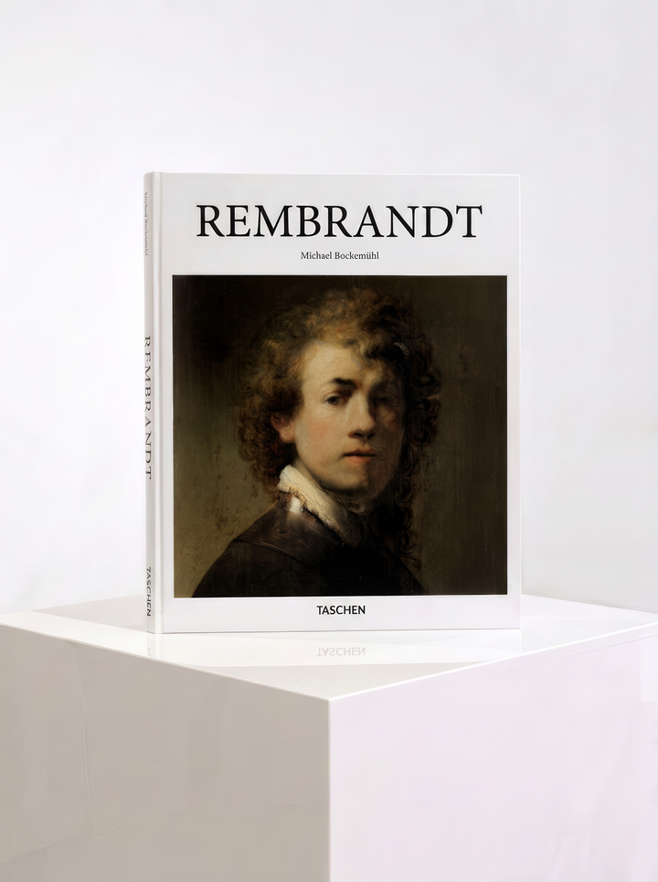 TASCHEN Rembrandt hardcover art book by Michael Bockemühl, featuring a self-portrait on the cover, displayed on a white plinth.
