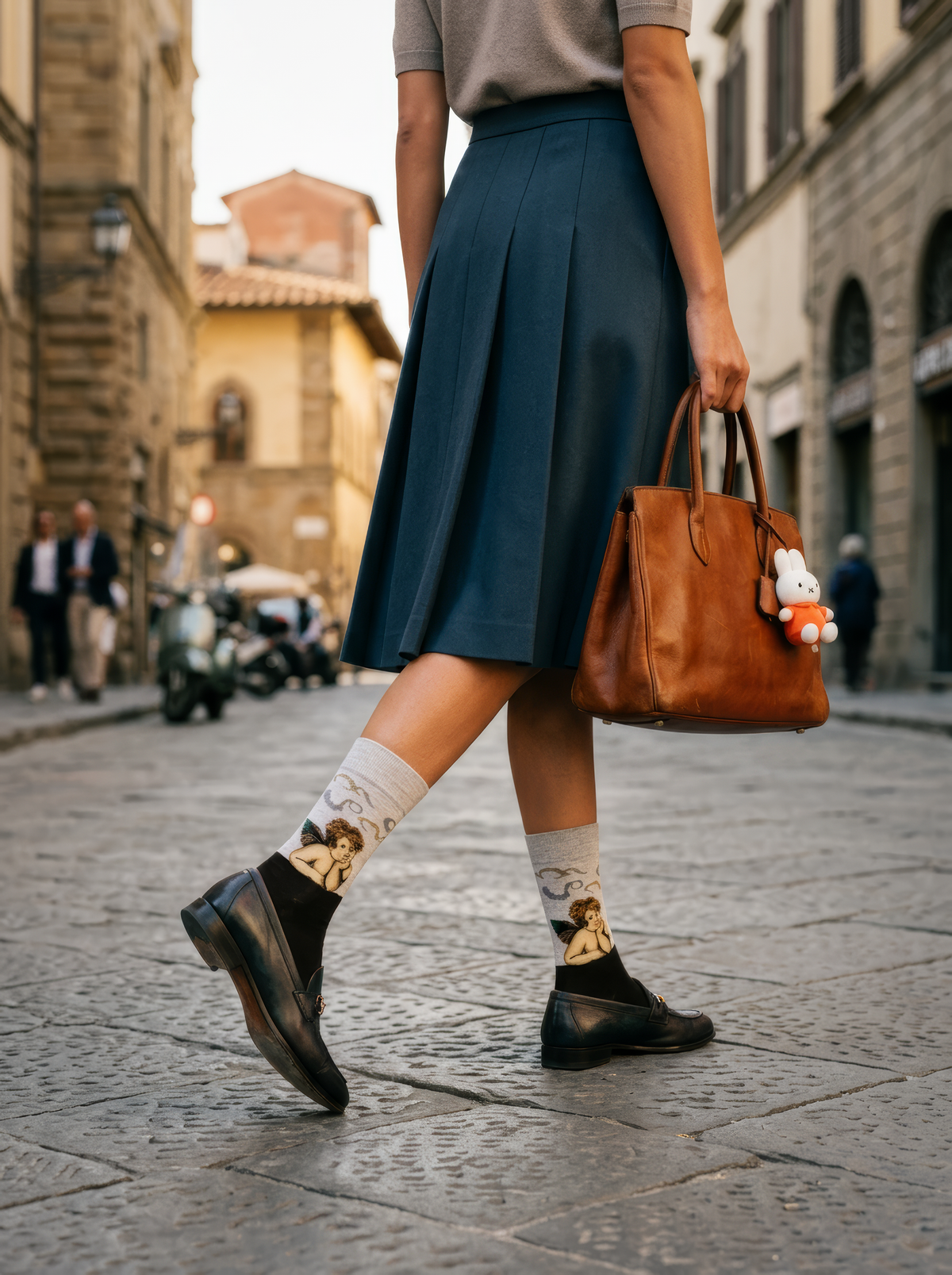 Sistine Madonna Angels art socks featuring Raphael’s artwork worn with black ankle shoes while walking in the city
