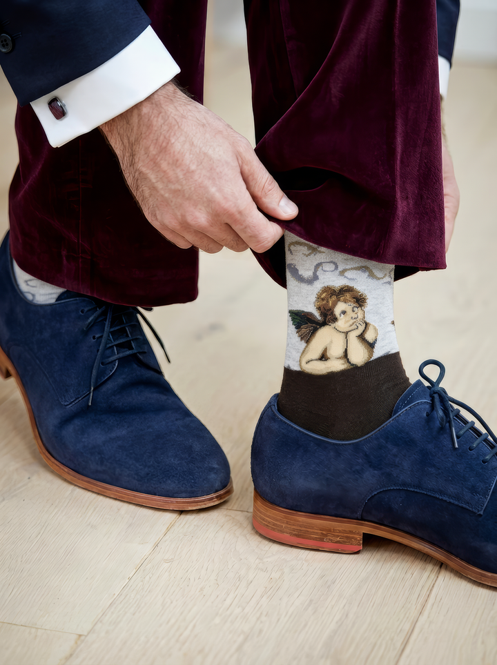 Sistine Madonna Angels art socks featuring Raphael’s artwork worn with blue shoes and dark trousers
