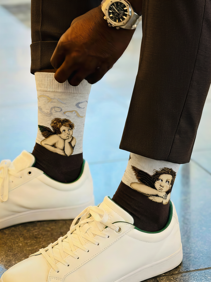 Sistine Madonna Angels art socks featuring Raphael’s artwork worn with white sneakers and dark trousers