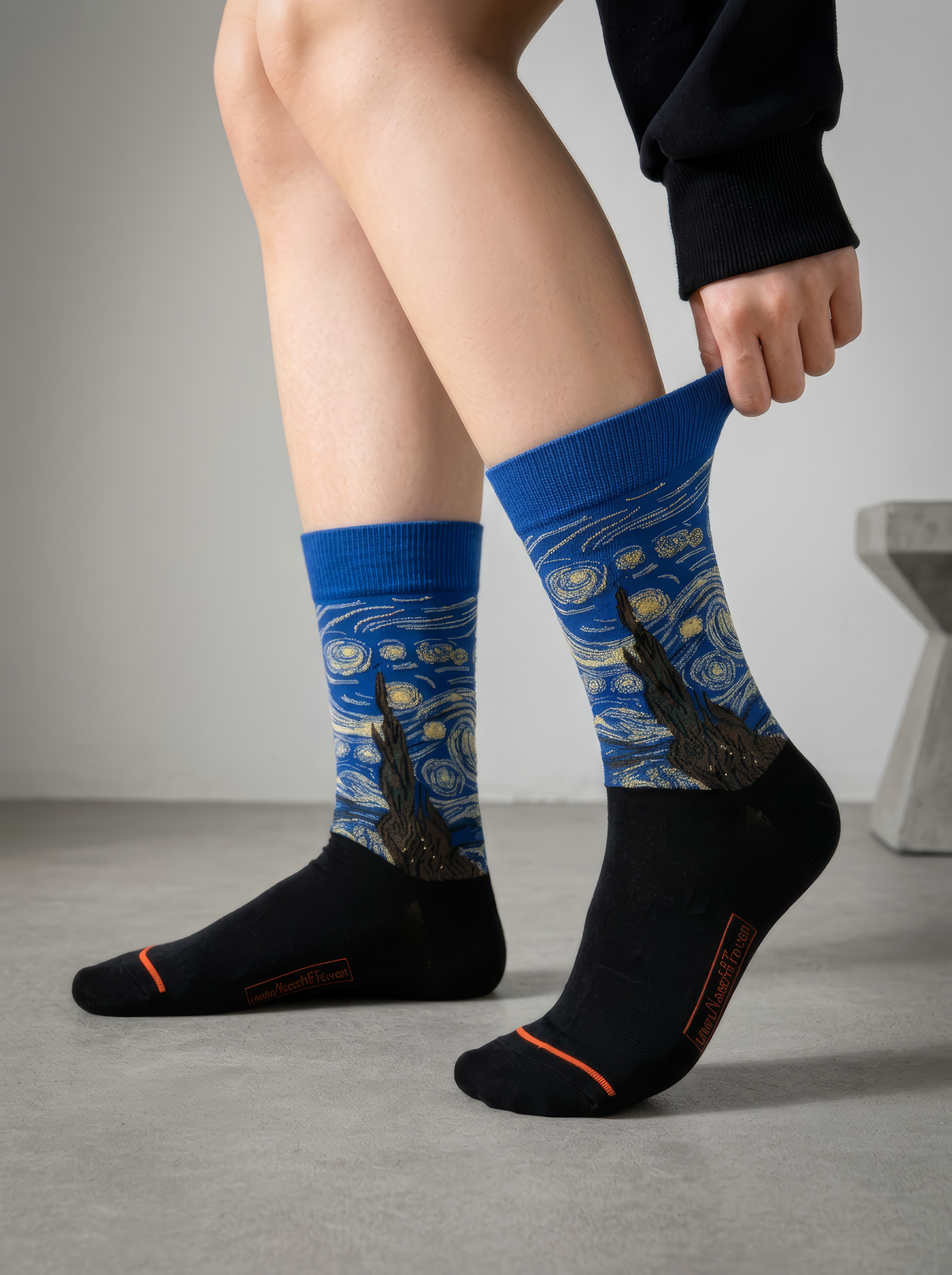 Close-up of Starry Night Classic art socks by Vincent van Gogh being adjusted in a bright studio setting