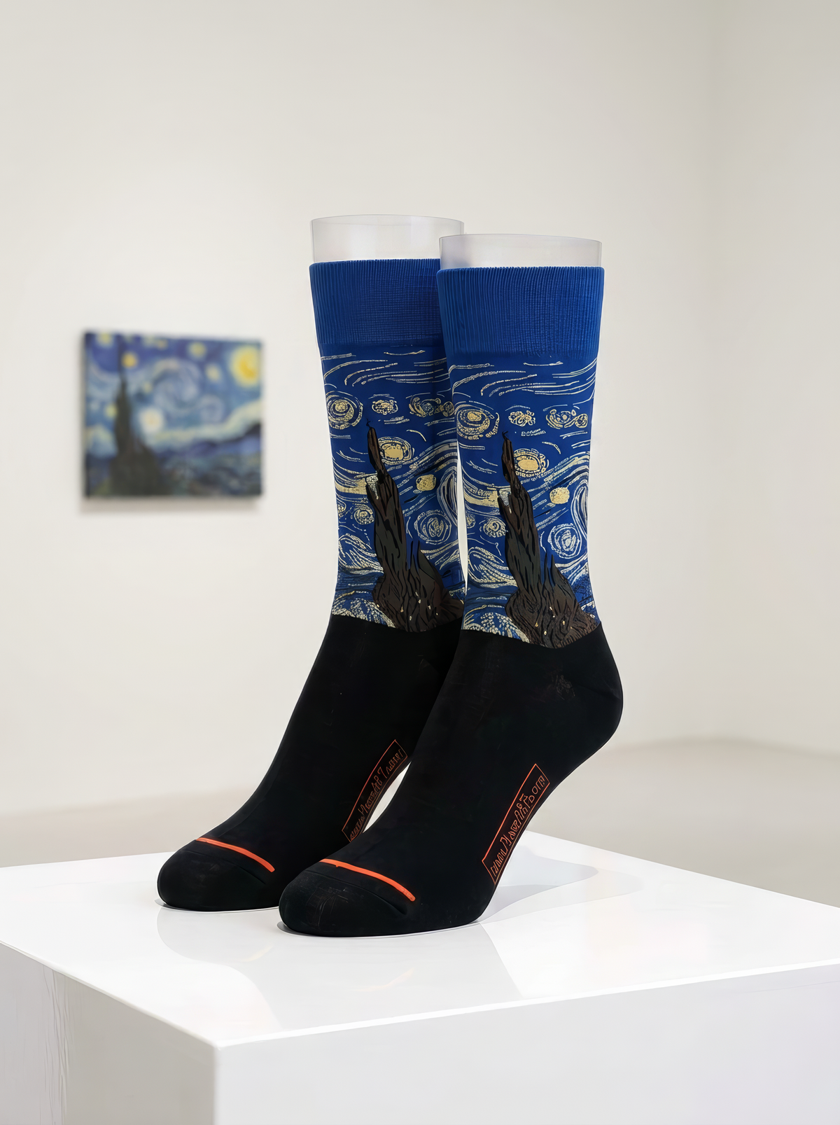 Starry Night Classic art socks by Vincent van Gogh displayed on a white pedestal in a museum-style interior

