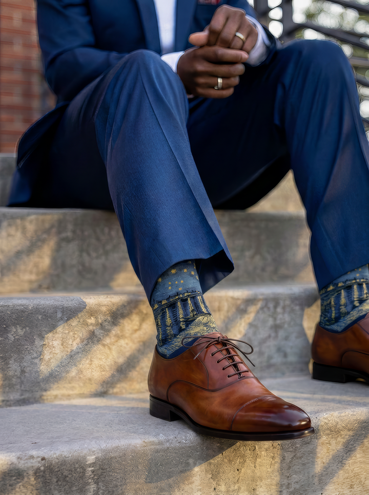 Starry Night over the Rhône art socks by Vincent van Gogh worn with brown leather Oxford shoes and a blue suit on stone steps⠋

