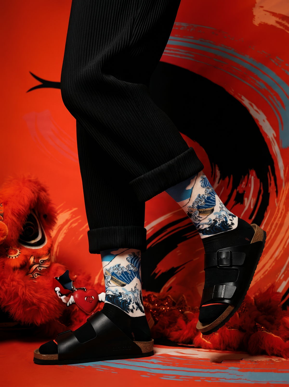 The Great Wave (Classic) art socks by Katsushika Hokusai styled with black shoes against a red background