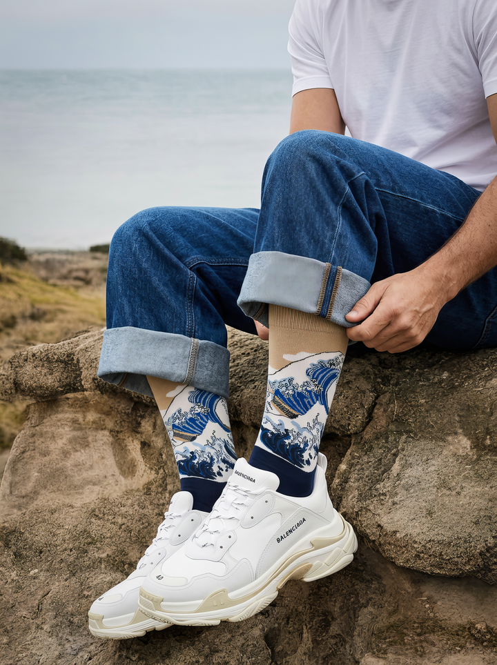 The Great Wave (Classic) art socks by Katsushika Hokusai worn with white sneakers beside the coast