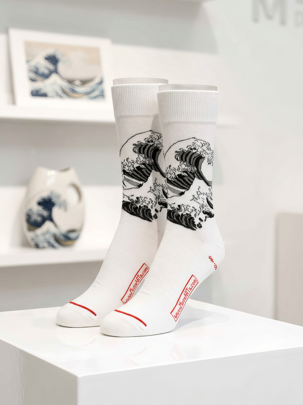 White The Great Wave black and white art socks by Katsushika Hokusai displayed on a white pedestal
