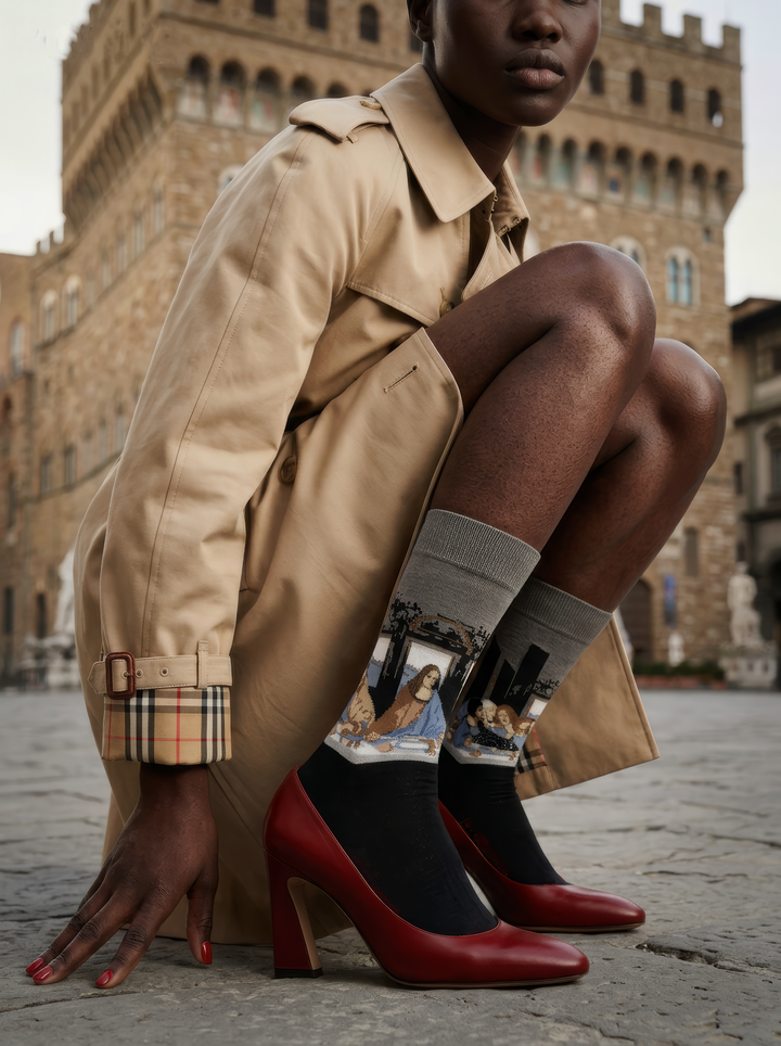 The Last Supper art socks featuring Leonardo da Vinci’s artwork worn with red high-heeled shoes and beige trousers

