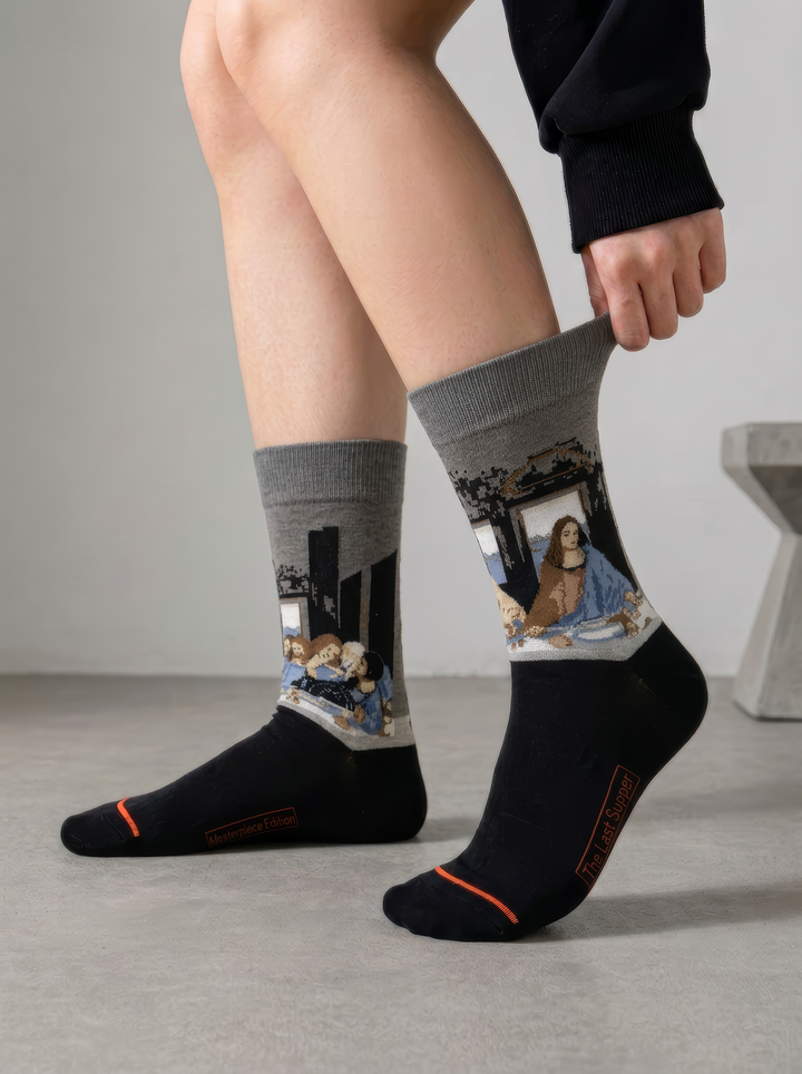 Person wearing black and grey The Last Supper art socks featuring Leonardo da Vinci’s artwork without shoes