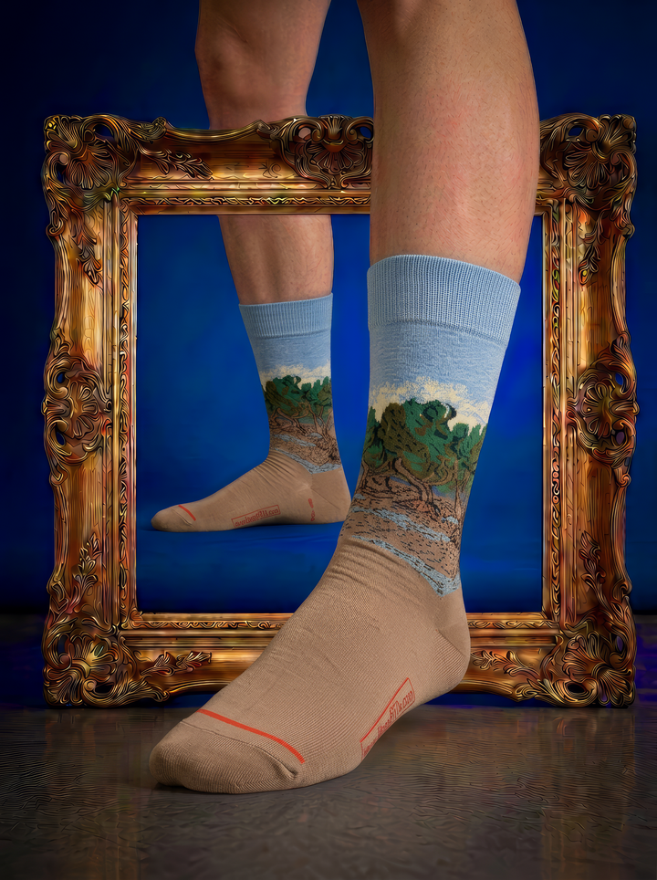 The Olive Trees art socks by Vincent van Gogh displayed without shoes in front of an ornate gold frame