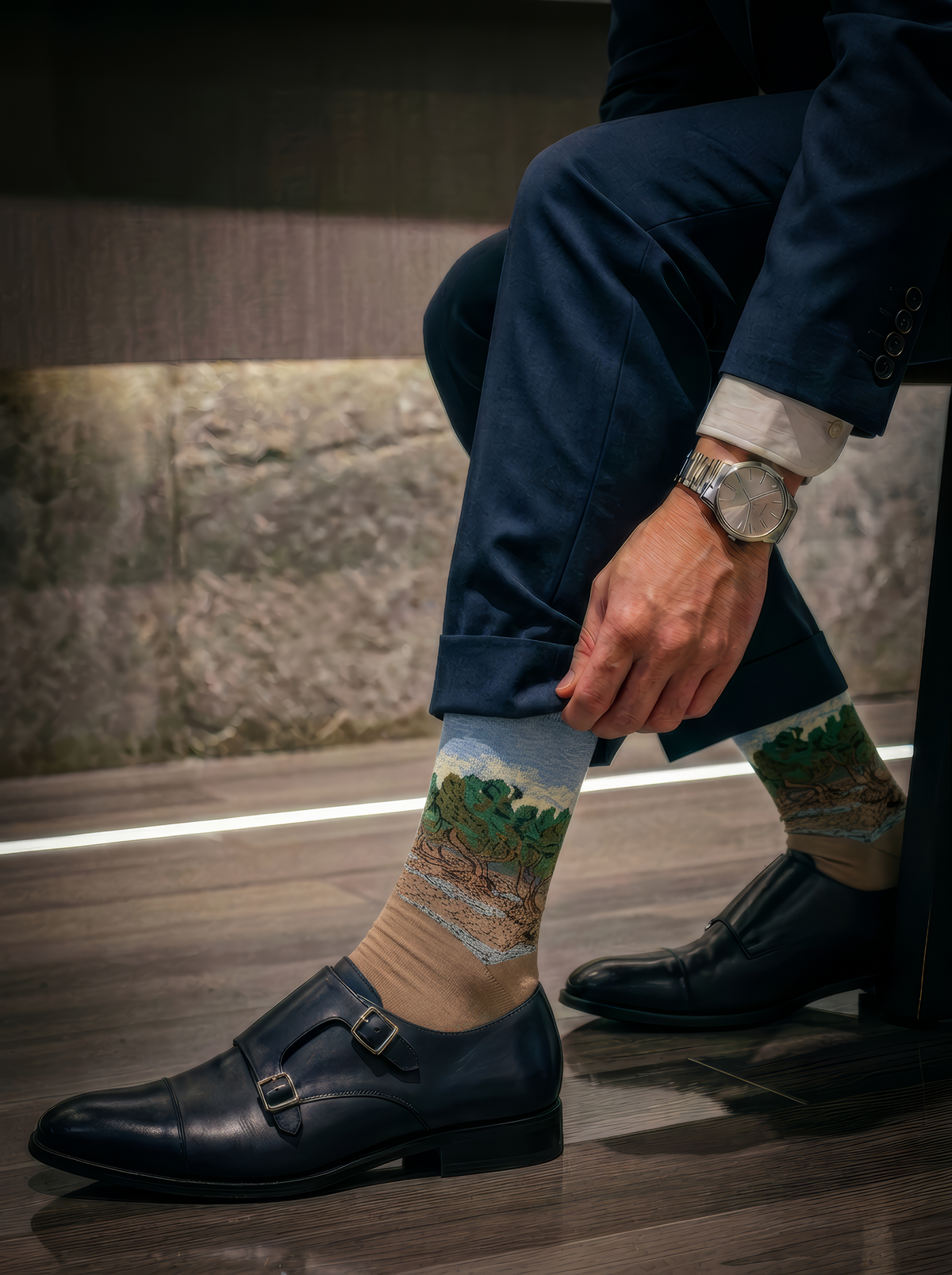 The Olive Trees art socks by Vincent van Gogh worn with black loafers while seated on stone steps