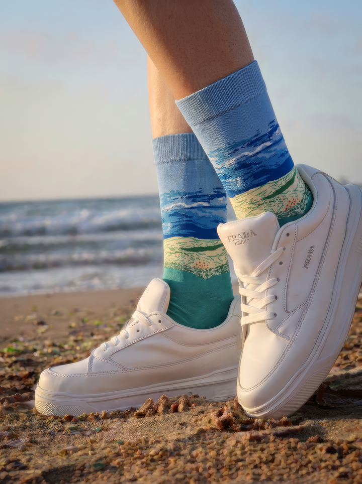 Wheat Field under Thunderstorm Sky art socks worn with white sneakers on a rocky beach