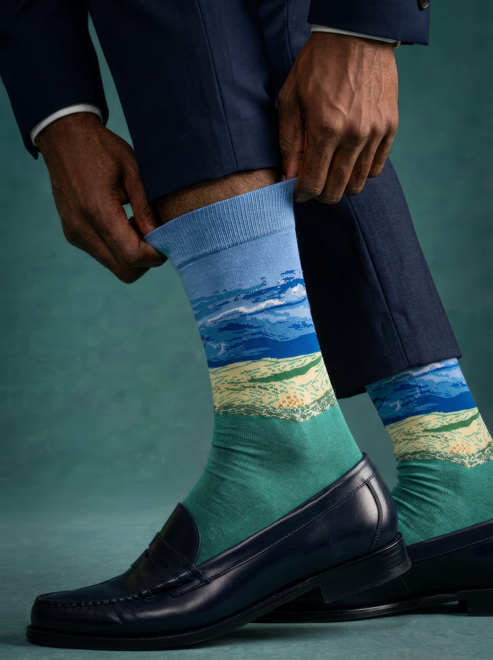 Wheat Field under Thunderstorm Sky unisex art socks by Vincent van Gogh worn with black leather penny loafers and navy trousers⠋

