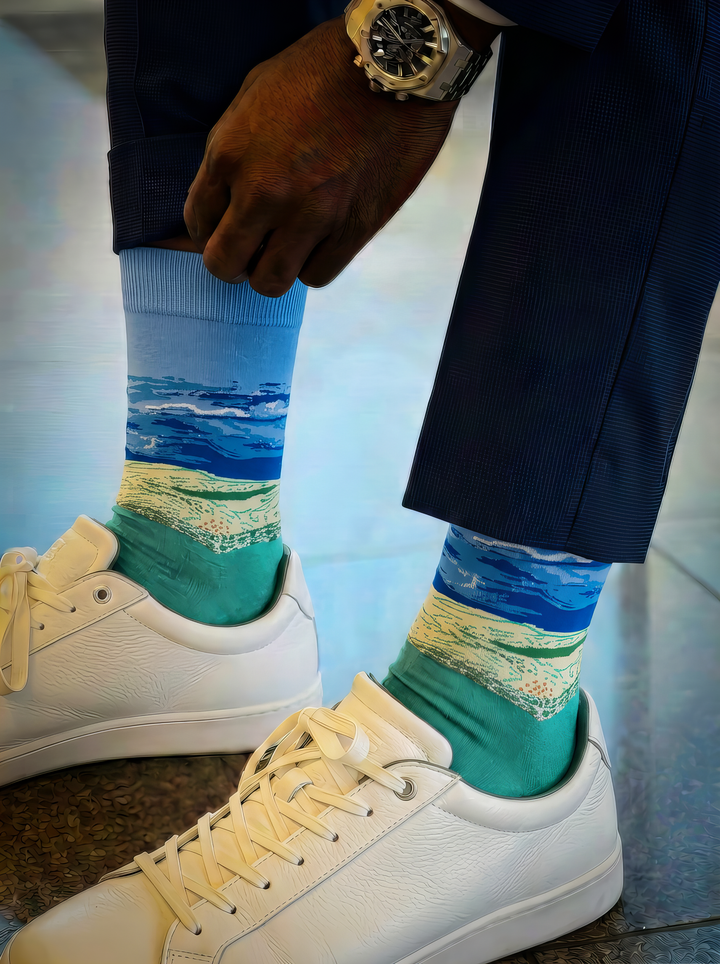 Wheat Field under Thunderstorm Sky unisex art socks by Vincent van Gogh worn with white lace-up sneakers and navy trousers⠋

