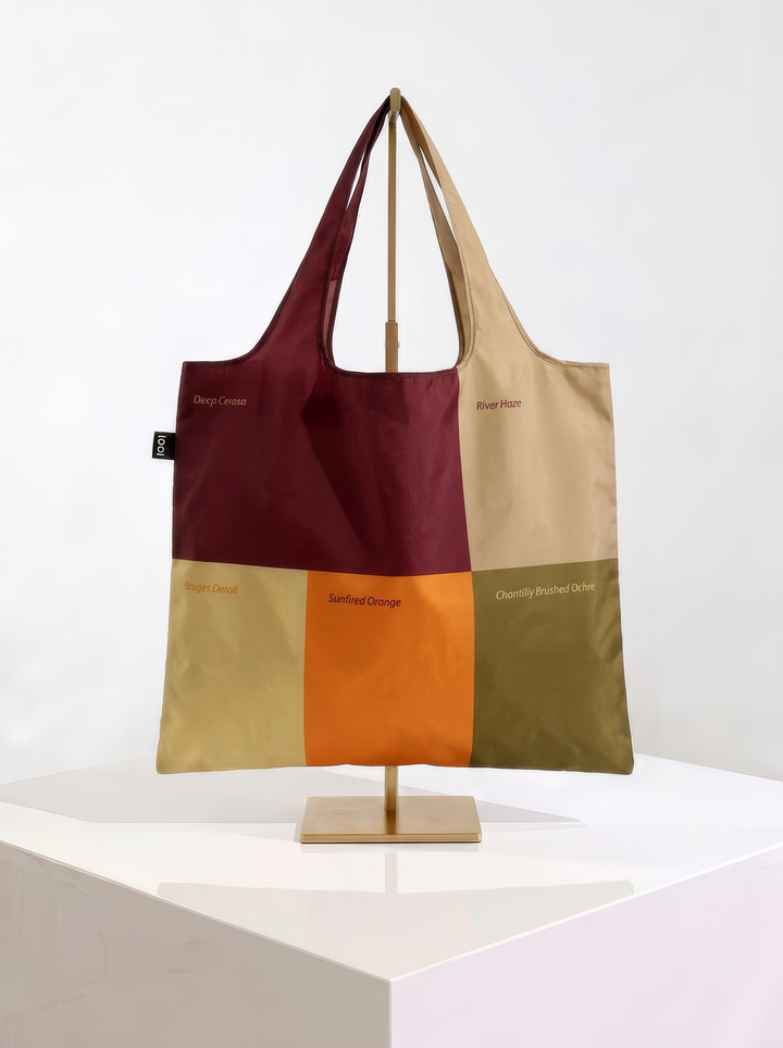 Reverse of the Whistlejacket shopper bag, showing burgundy, cream, ochre and olive colour blocks, displayed on a stand.
