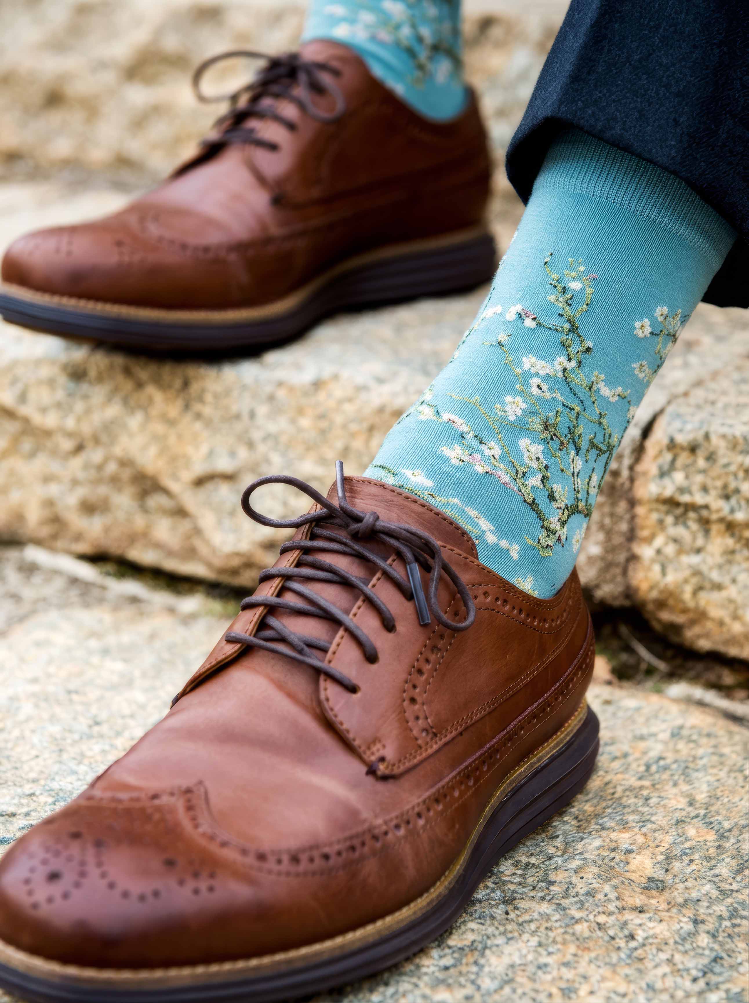 Man wearing Van Gogh Almond Blossom art socks with brown Oxford shoes on cobblestones — ArtyGifts