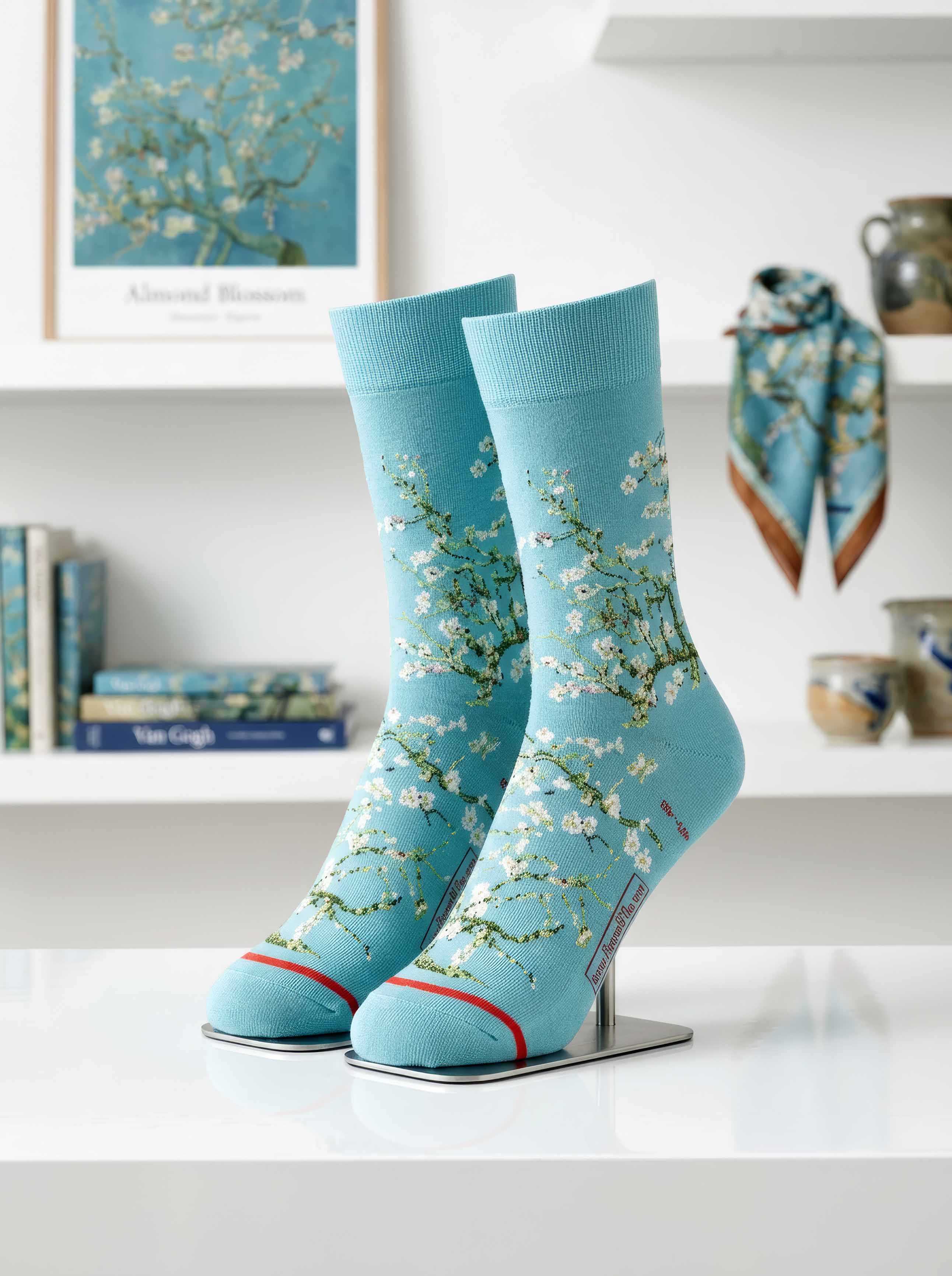 Van Gogh Almond Blossom art socks on display stand, with Almond Blossom painting and scarf in background — ArtyGifts