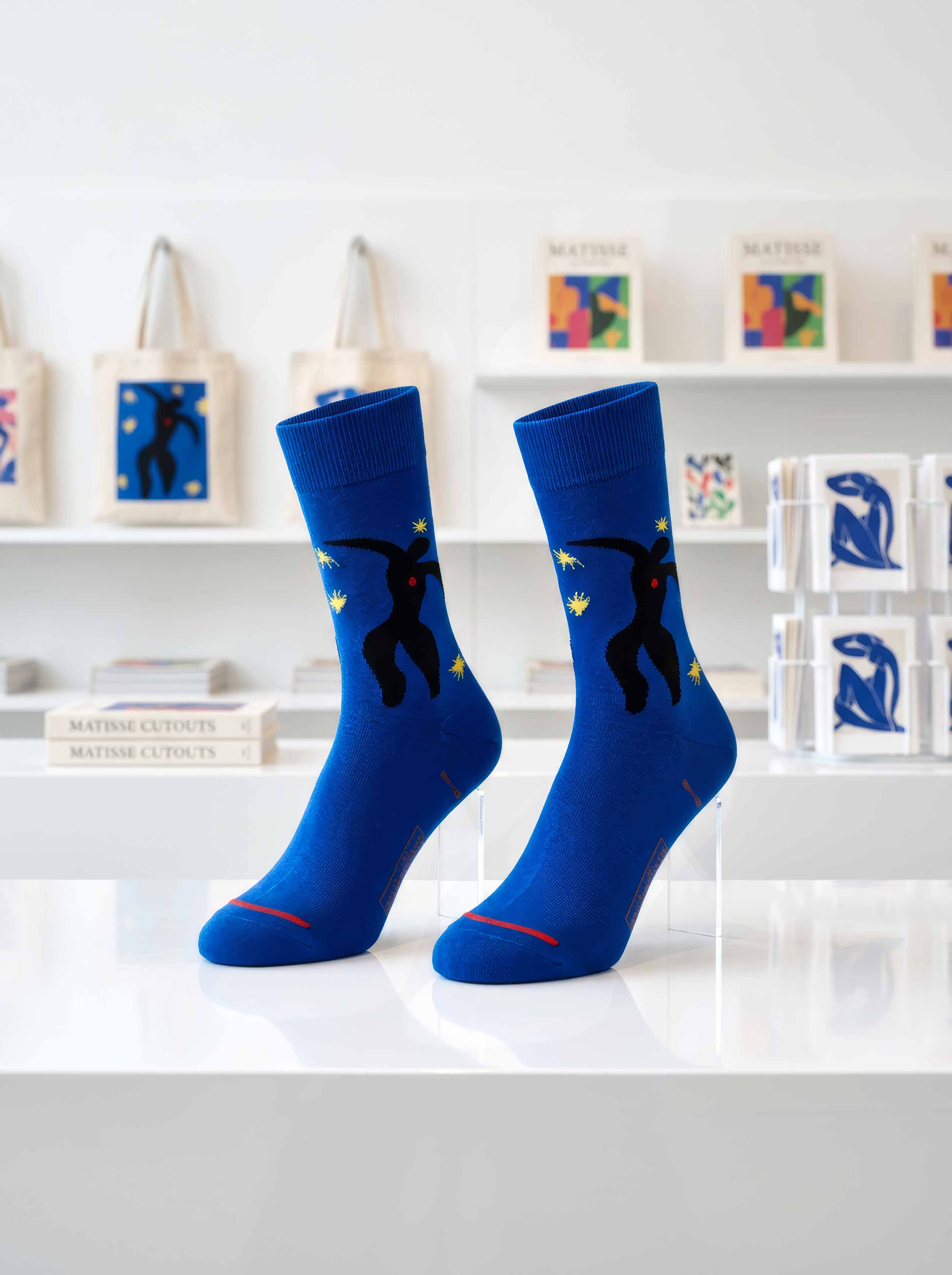 Matisse Icarus art socks displayed in museum gallery with Matisse artworks — unisex gift ArtyGifts