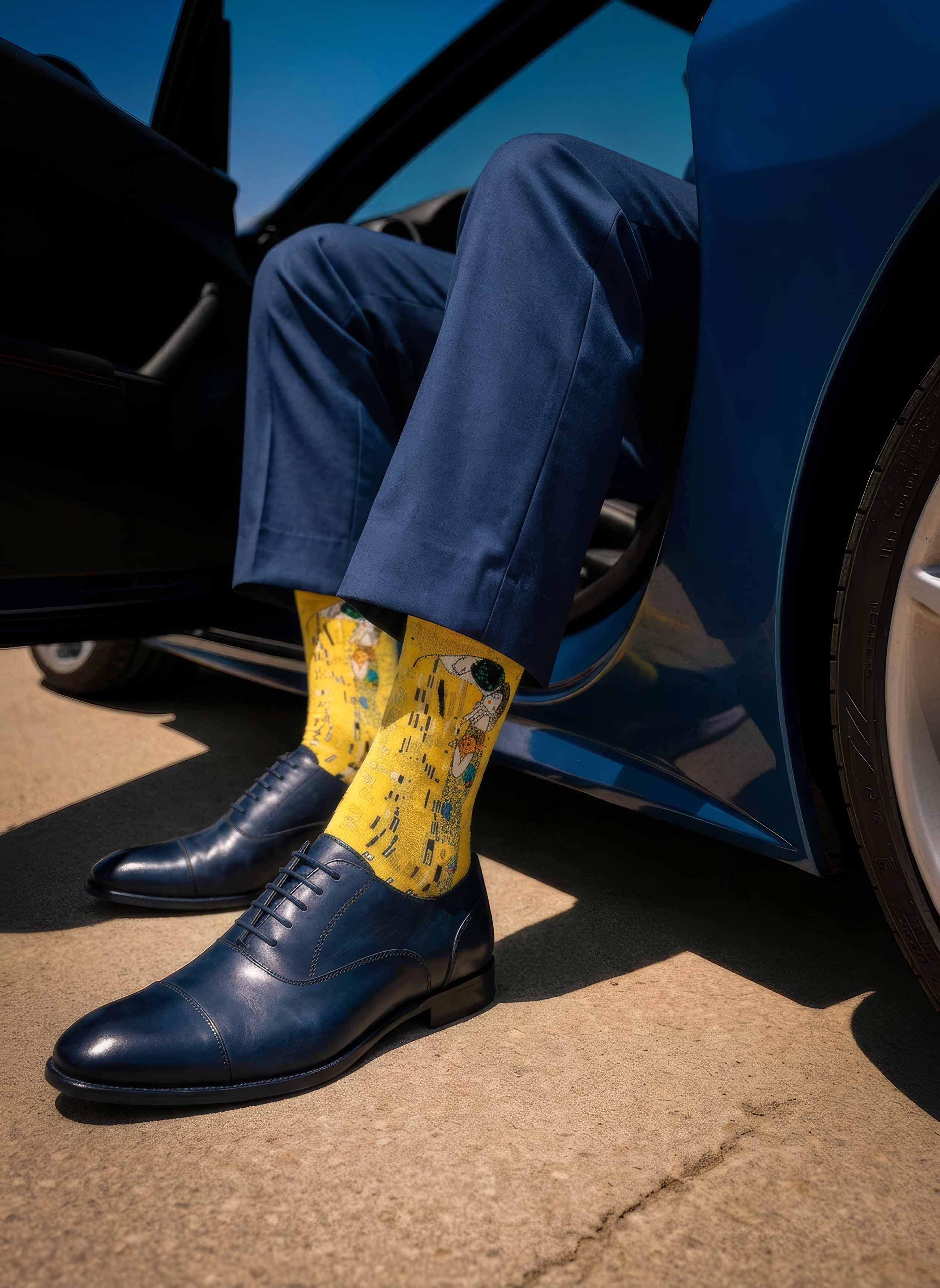 Man wearing MuseARTa Klimt The Kiss art socks with blue Oxford shoes by luxury car — premium Art Nouveau gift ArtyGifts

