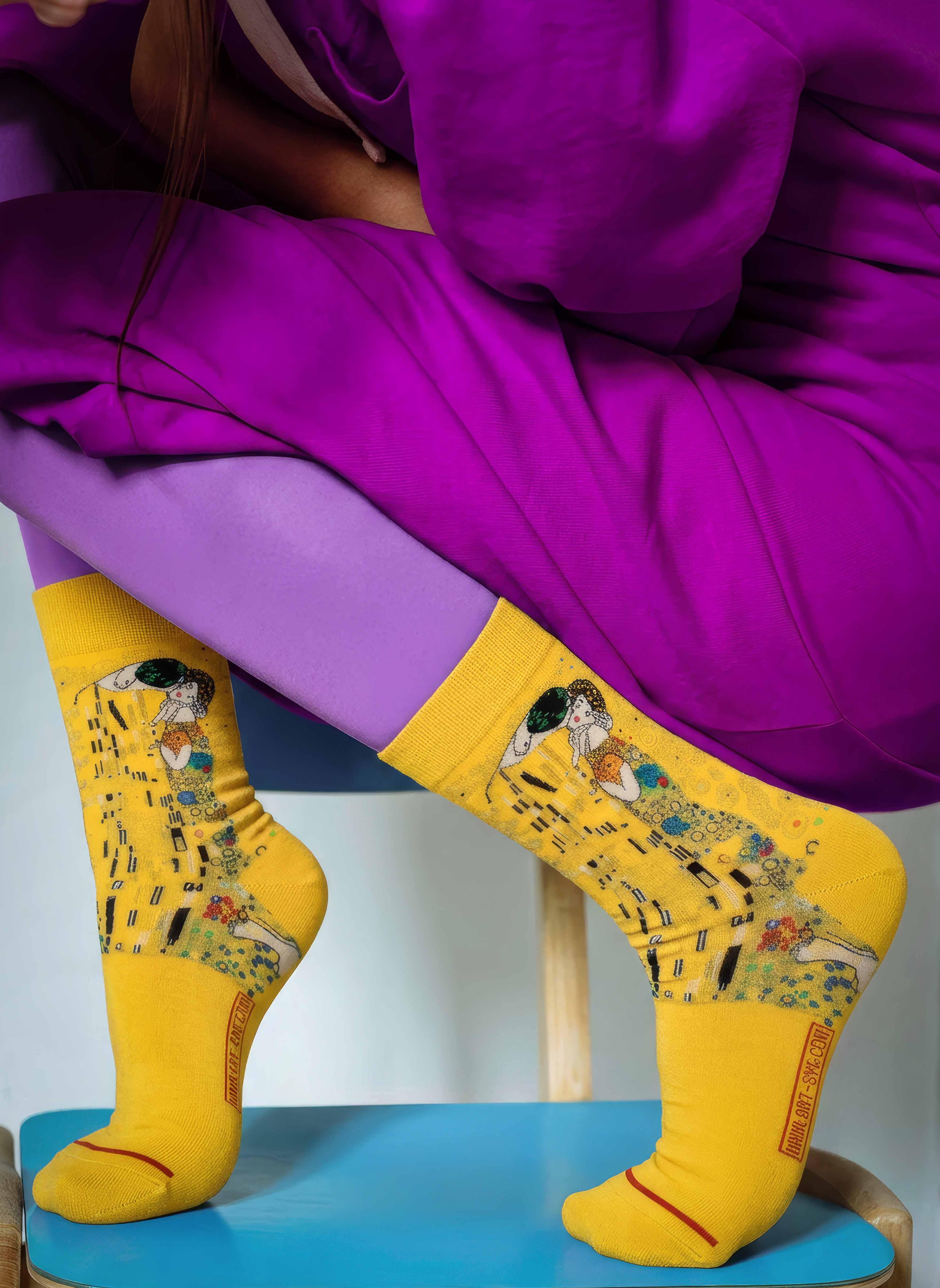 Woman in purple sitting wearing MuseARTa Klimt The Kiss art socks — Art Nouveau Belvedere Vienna gift ArtyGifts
